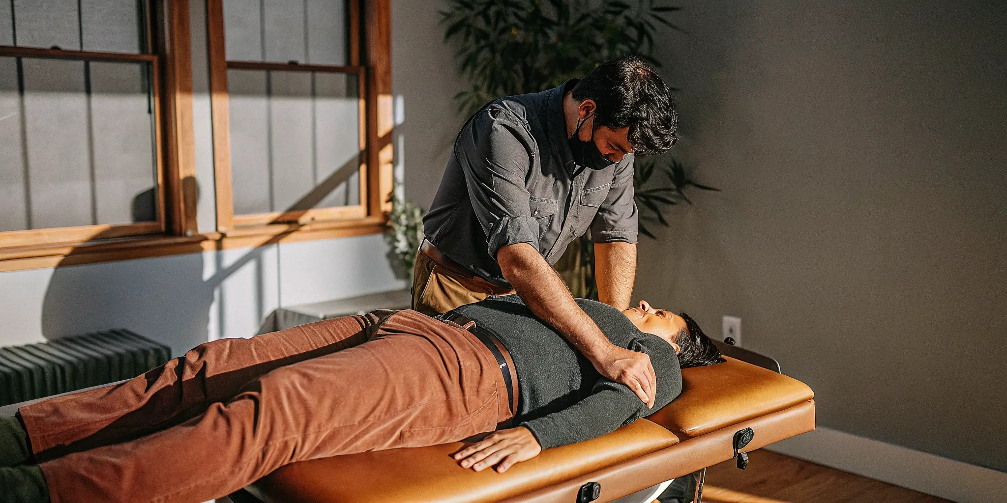 Chiropractor at Physio Logic NYC in Brooklyn performing manual spinal adjustment for back pain relief