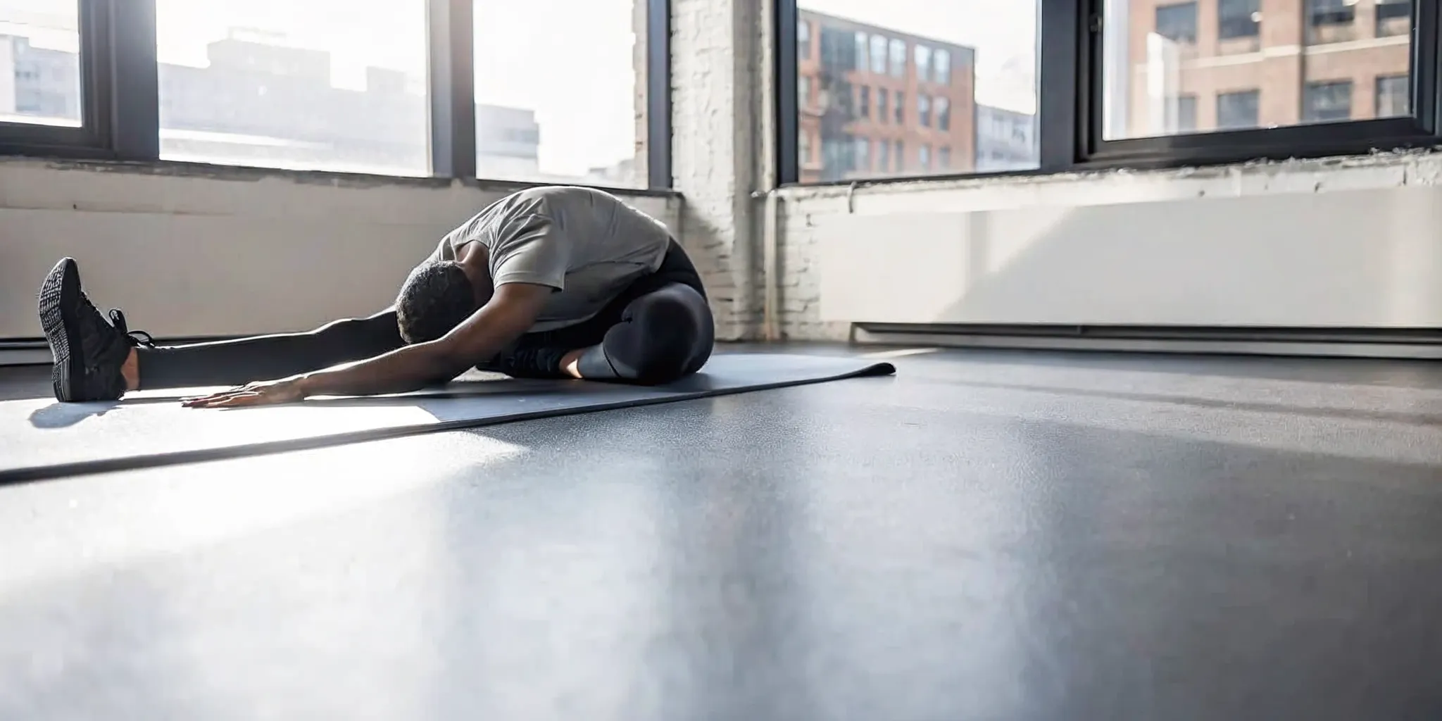 NYC desk worker doing a hip mobility stretch before a workout