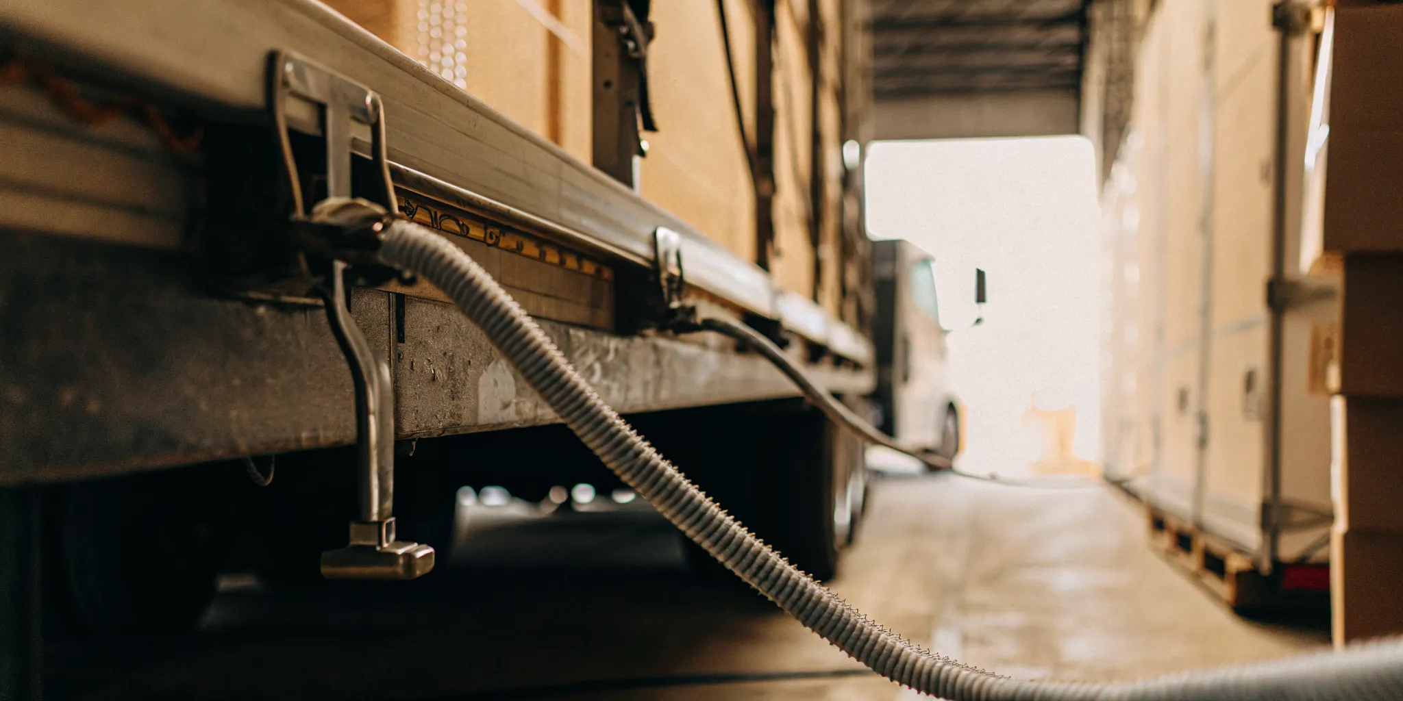 Sealed freight trailer moving through a cross-border customs inspection lane