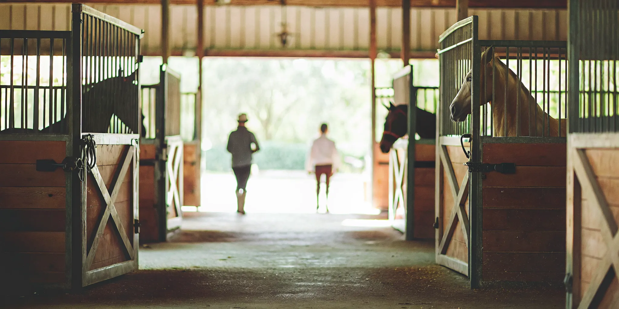 Premium all-aluminum end barn doors at an organized equestrian facility entrance