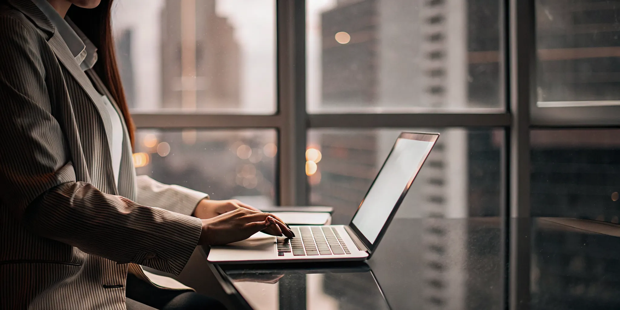 A customer service manager comparing different software systems on a laptop.