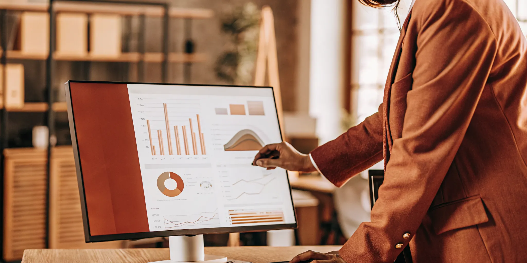 A professional customer support quality assurance manager analyzing charts and graphs representing call center QA sampling sizes.