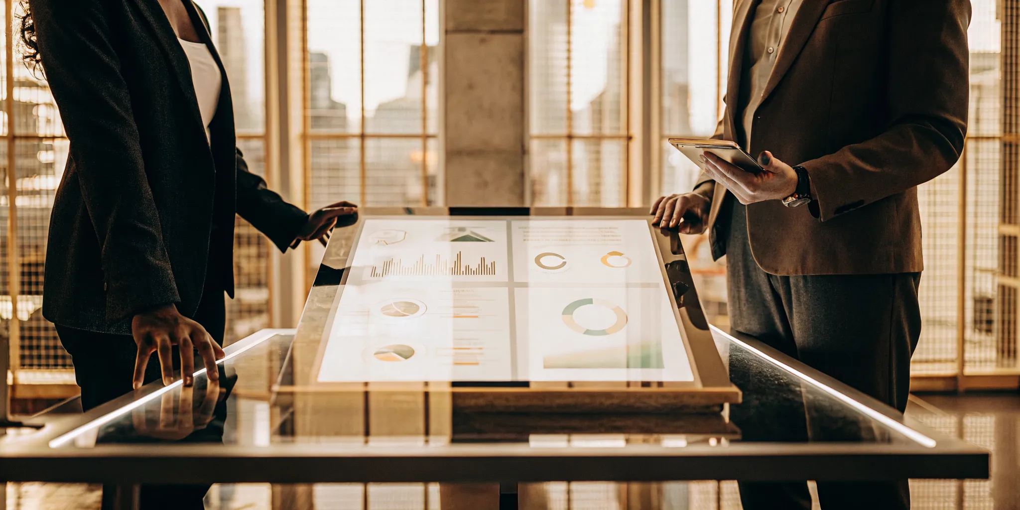 Insurance experts use a digital table to analyze data and improve claim accuracy.