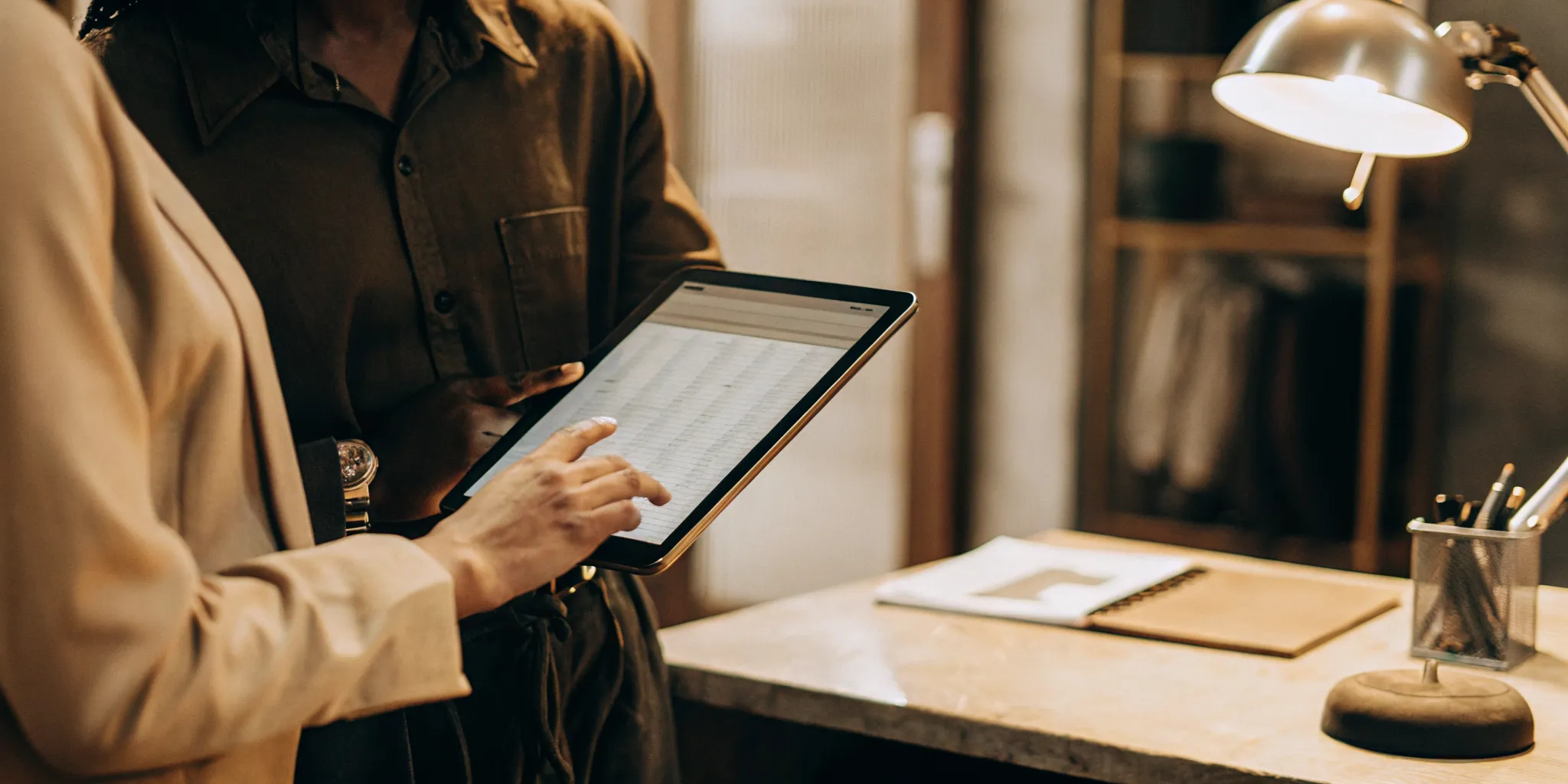 Claims professional reviewing quality scorecard data on a tablet in a modern office environment