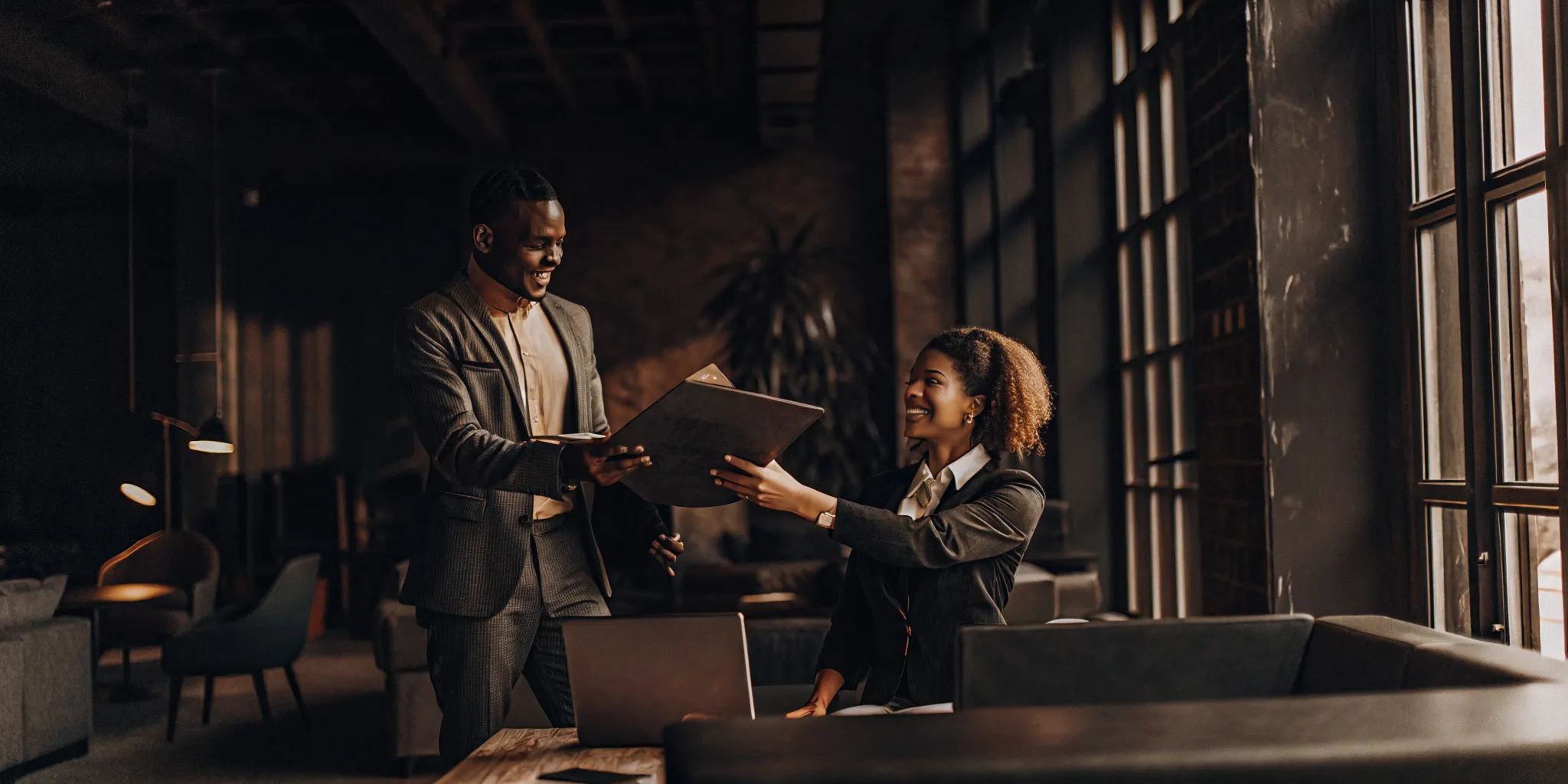 Supervisor recognizing contact center agent achievement in a modern office setting