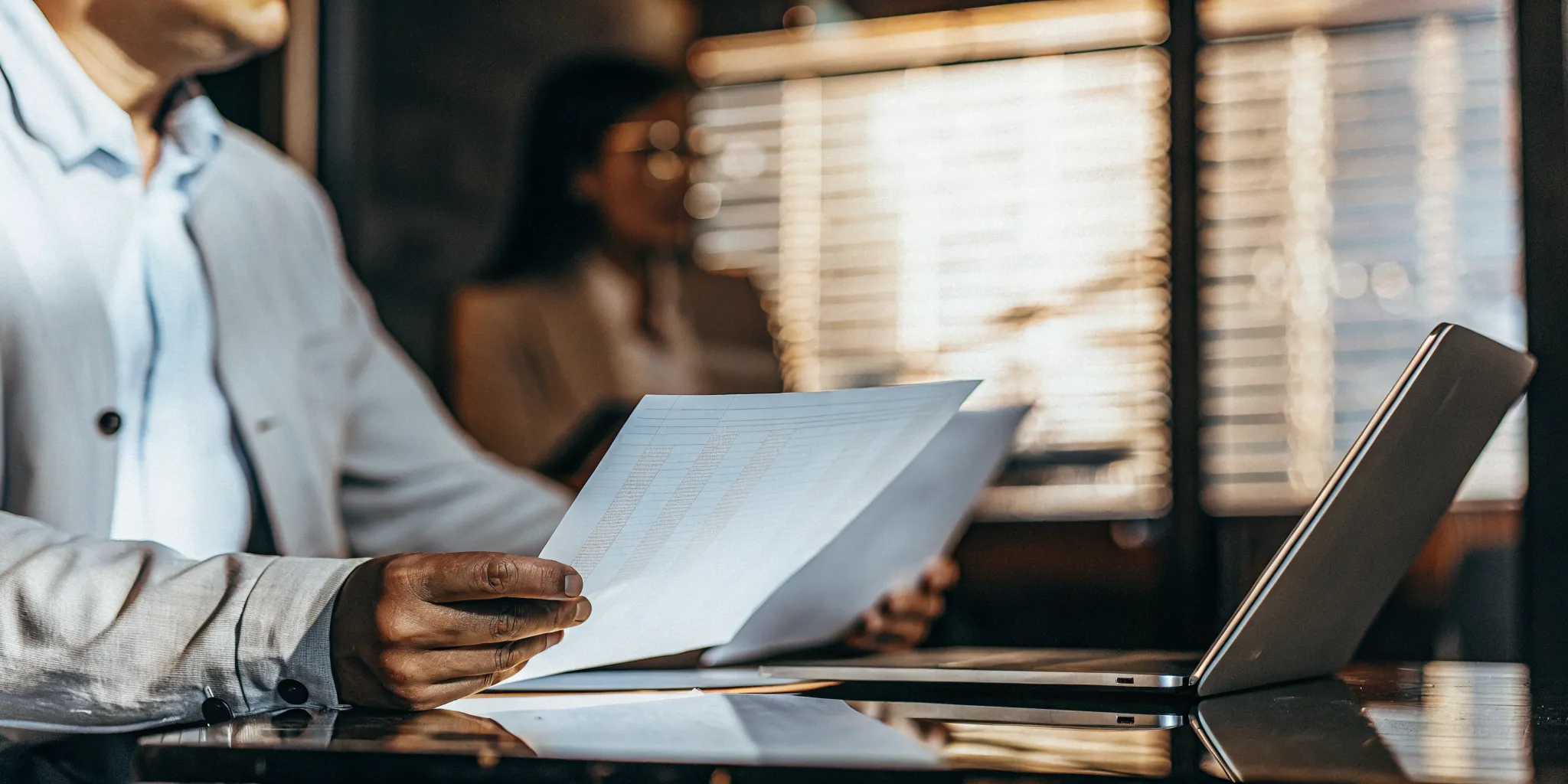 Insurance claims professional reviewing documents and a QA scorecard in a modern office