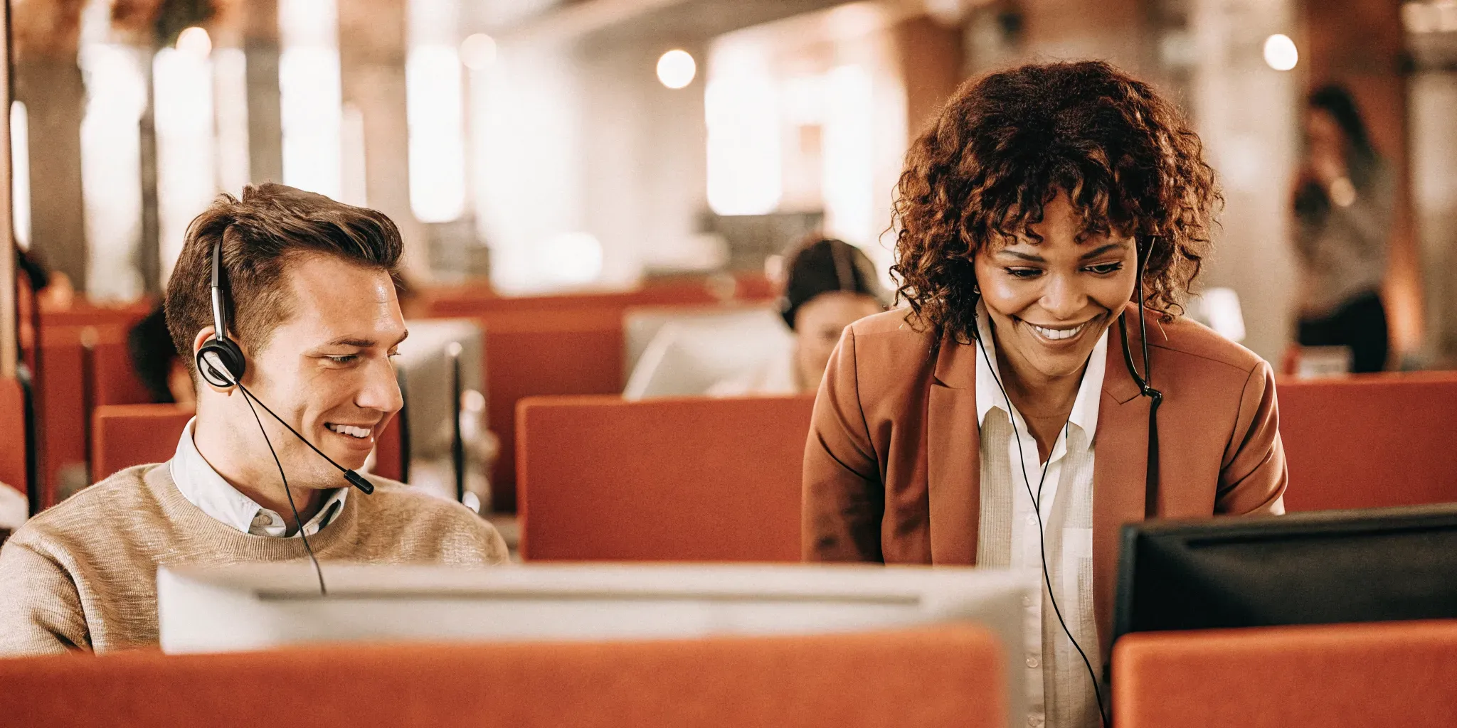 A call center supervisor and customer service agent reviewing an employee development roadmap together on a computer screen.
