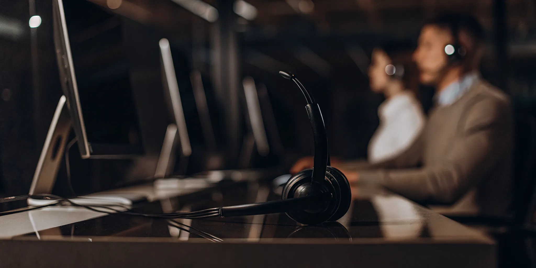 A modern call center using AI for quality assurance to analyze agent performance.