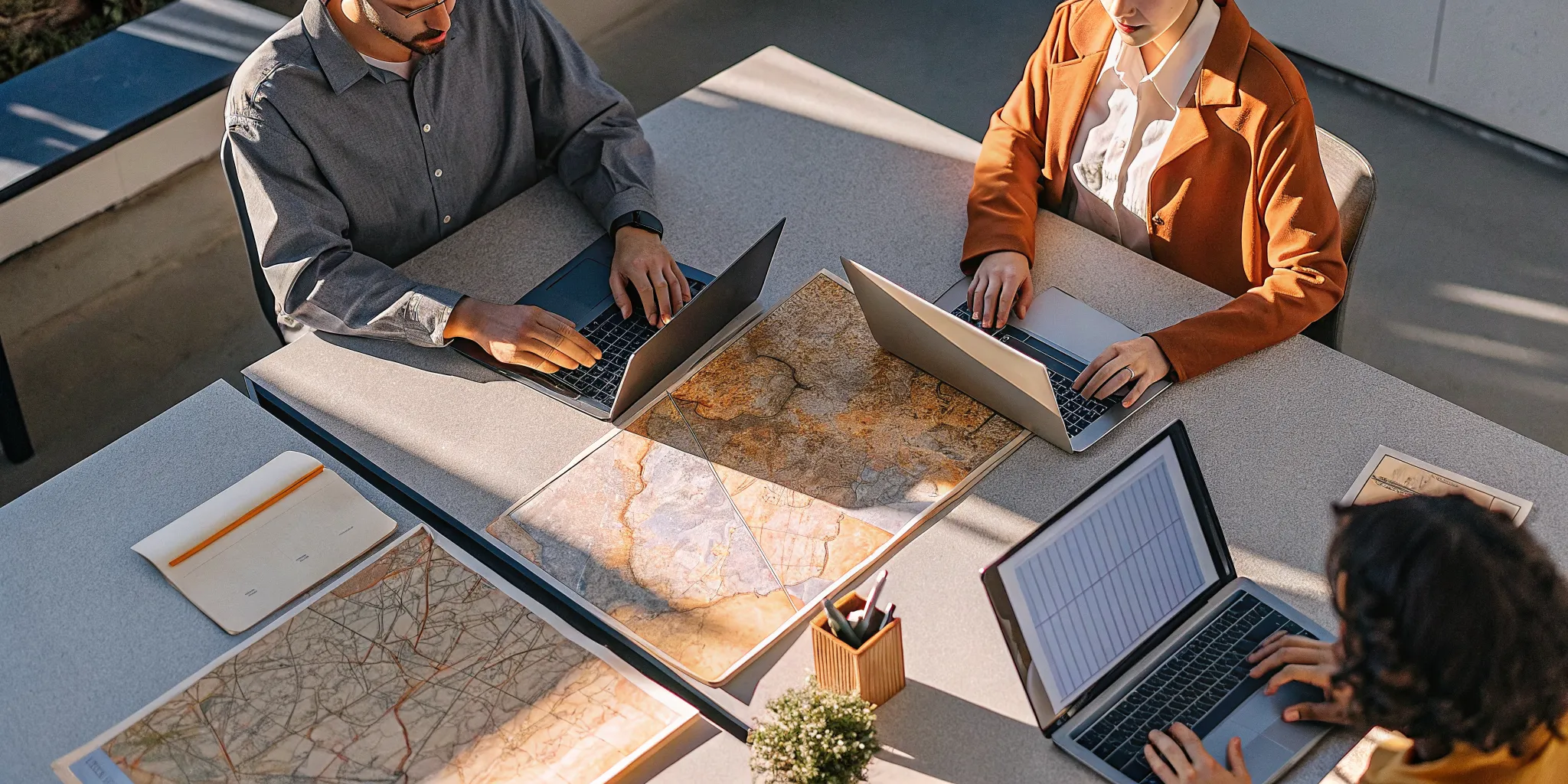 Tour operator team collaborating on business planning and software tools at a modern office workspace