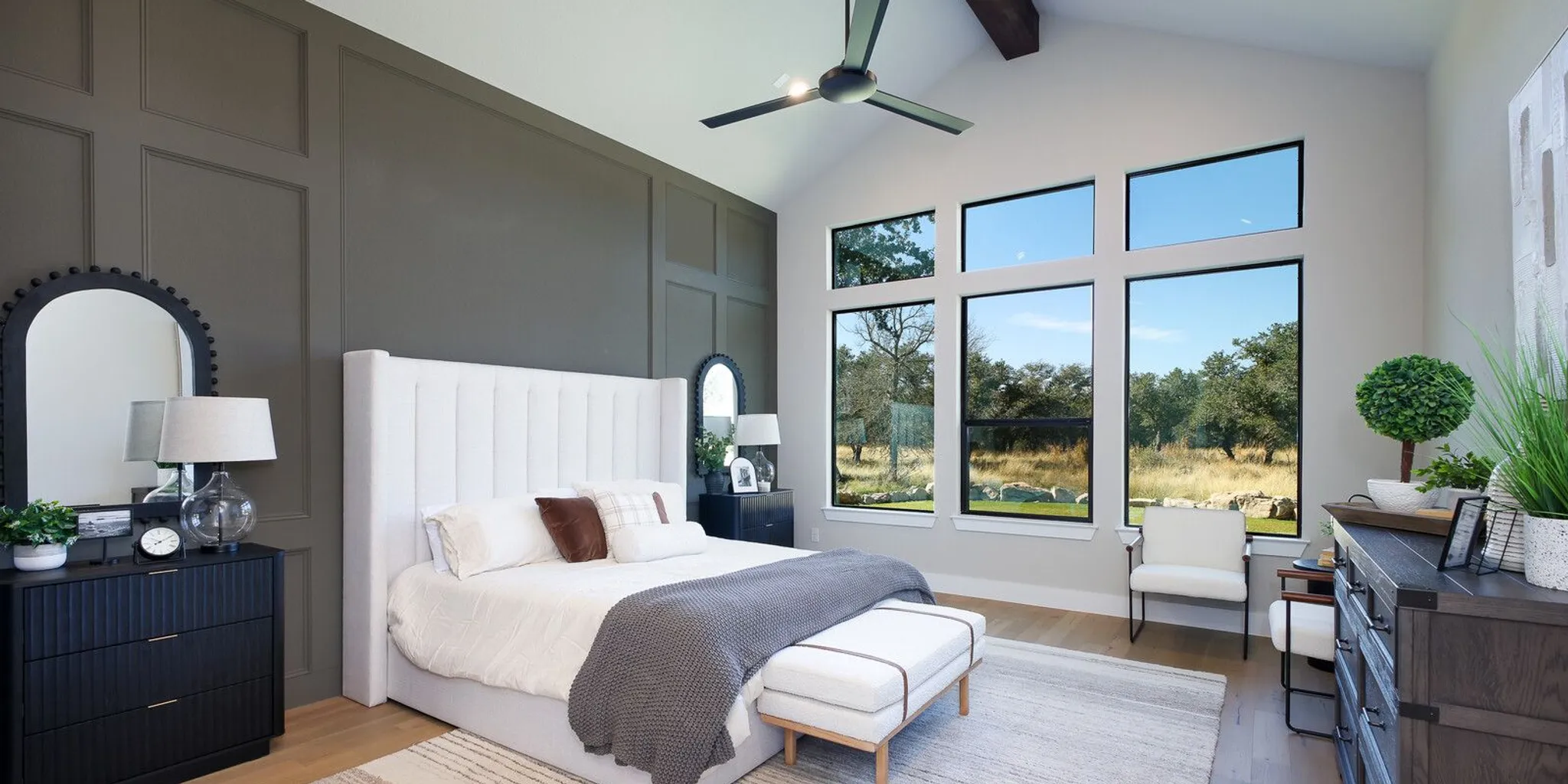 Custom home master suite design in Texas Hill Country with a spa-inspired bath and scenic windows