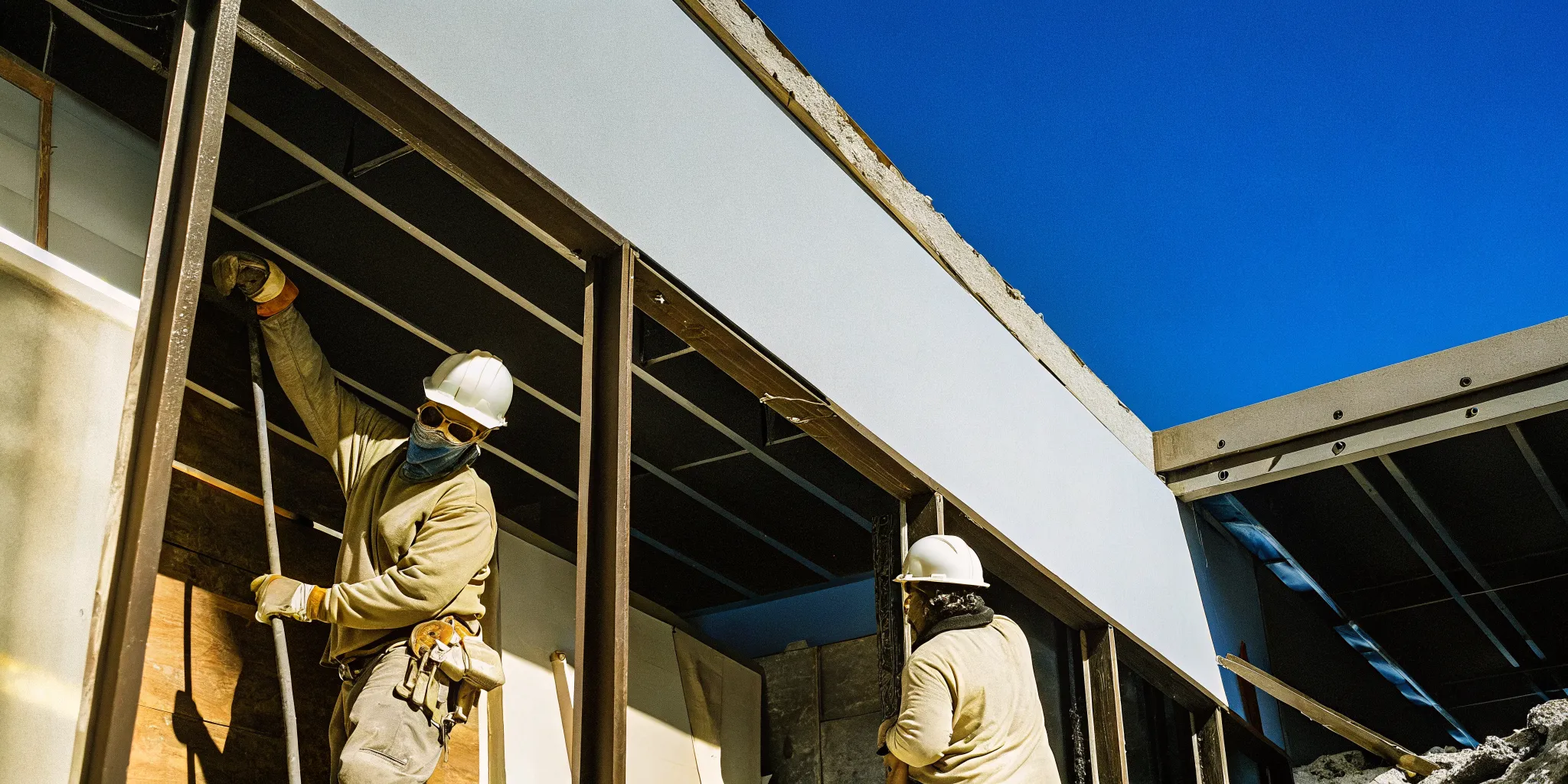 Selective demolition contractors removing interior partitions in a commercial building under renovation