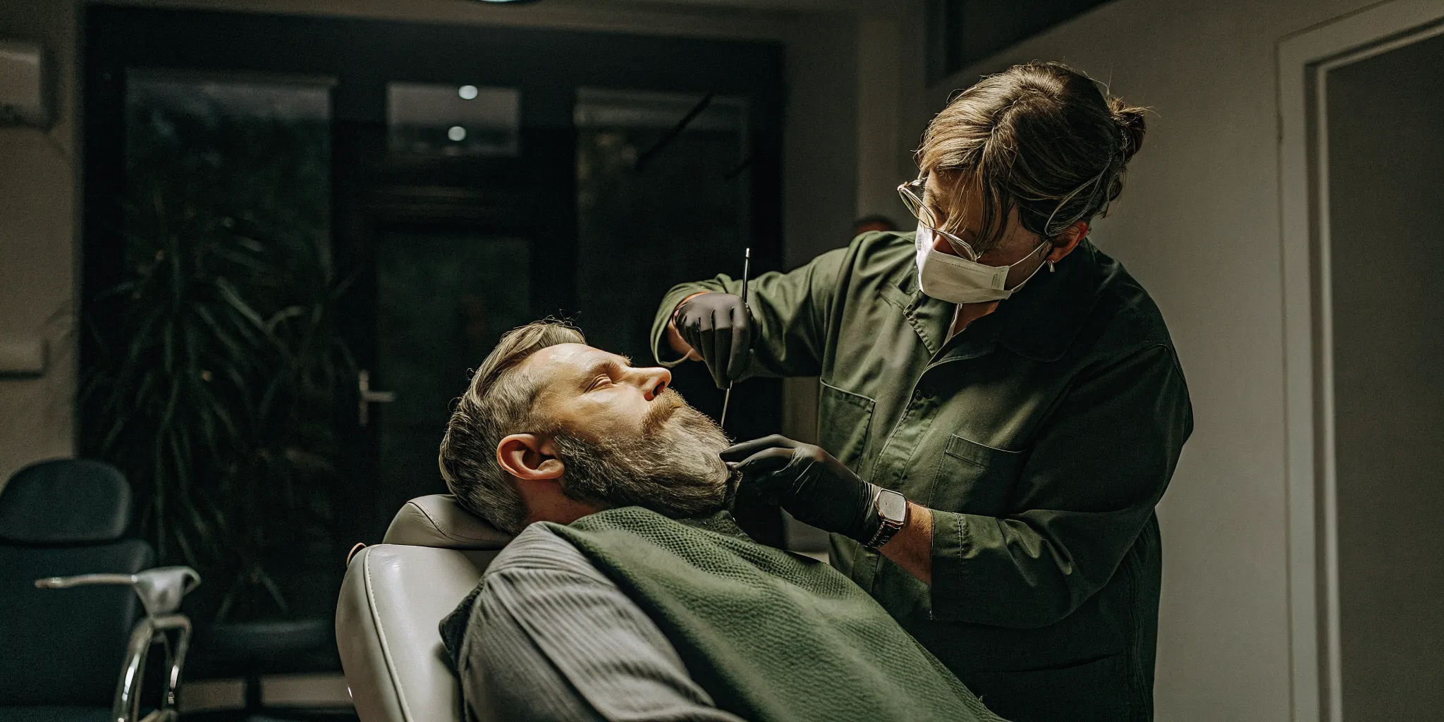Physician mapping natural beard hair direction before transplant treatment