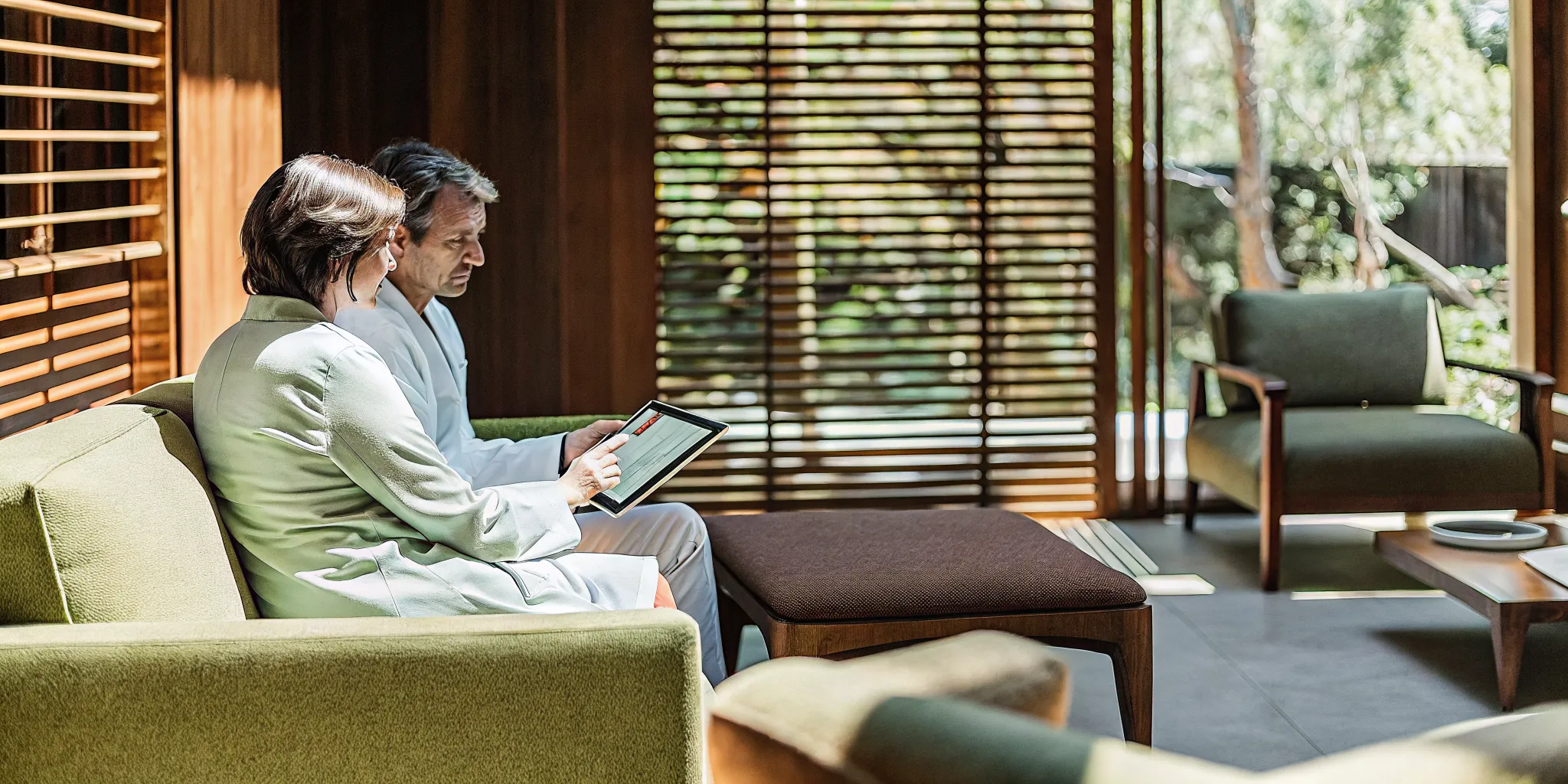 Hair Transplant vs Hair Loss Medication Long-Term Cost Comparison 1 Physician reviewing cost comparison chart with a patient in a modern consultation room