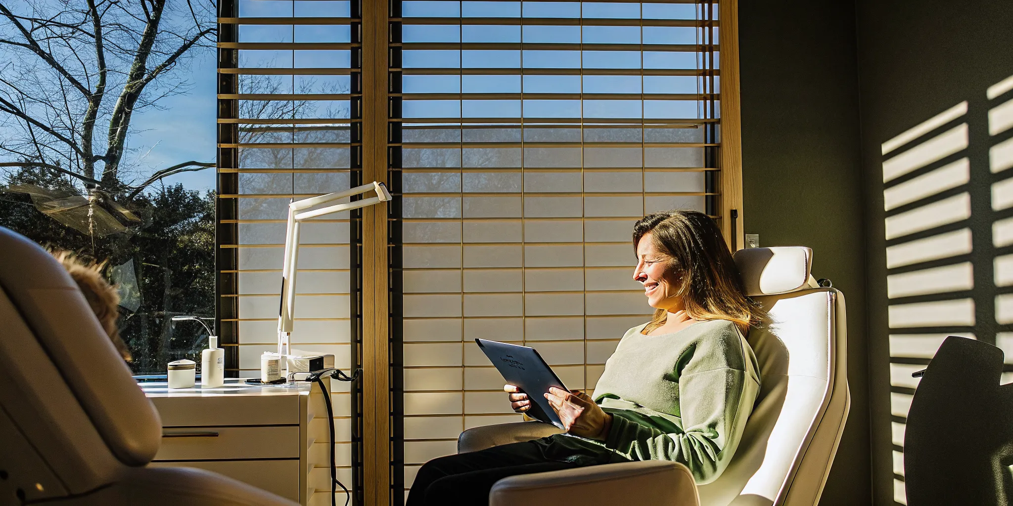 Patient reviewing financing options on a tablet in a modern hair restoration clinic consultation room