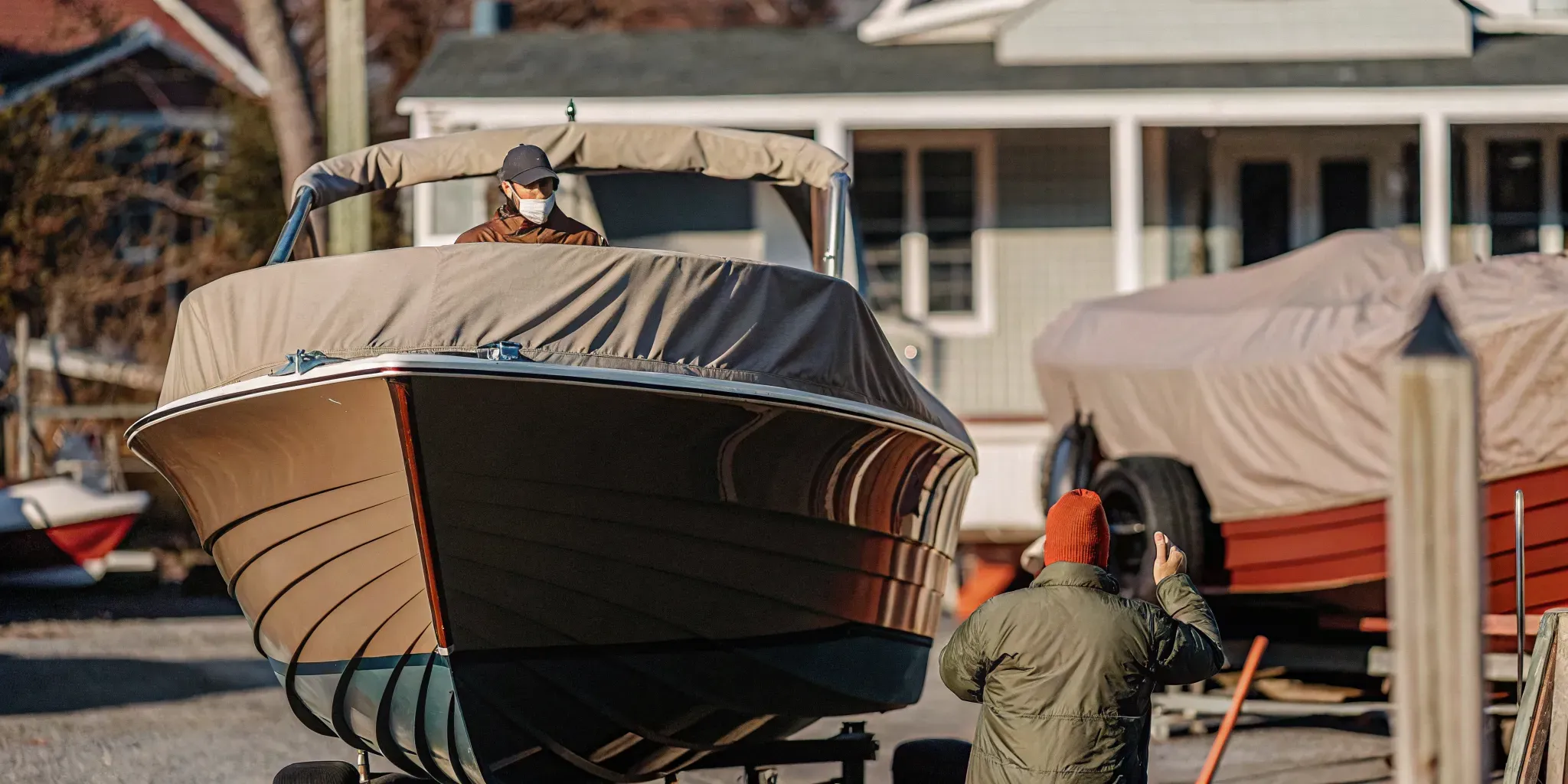Open recreational boat prepared for winter storage at a New England marina