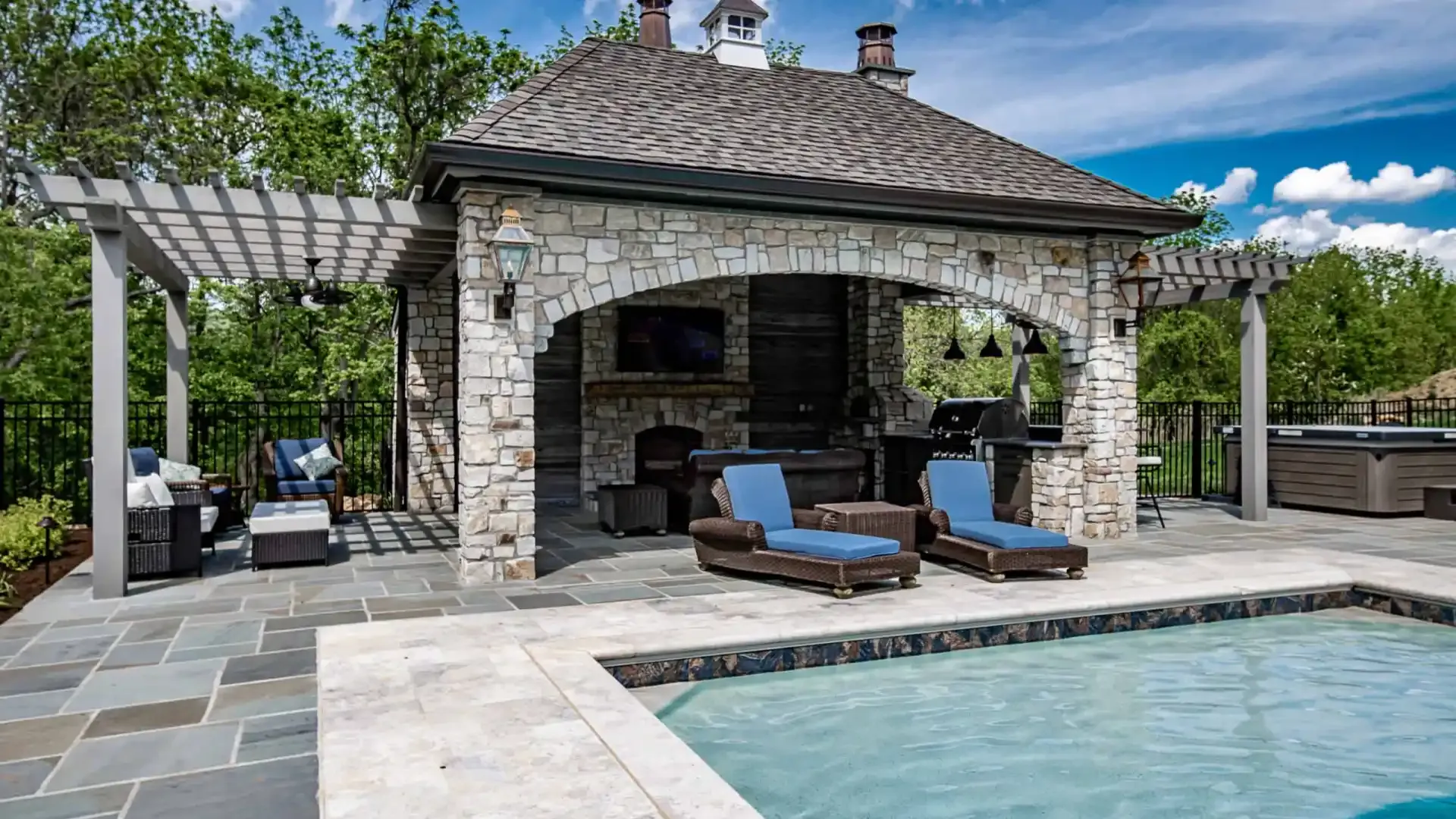 Custom natural stone patio with built-in seating area by DiSabatino in Delaware County, PA