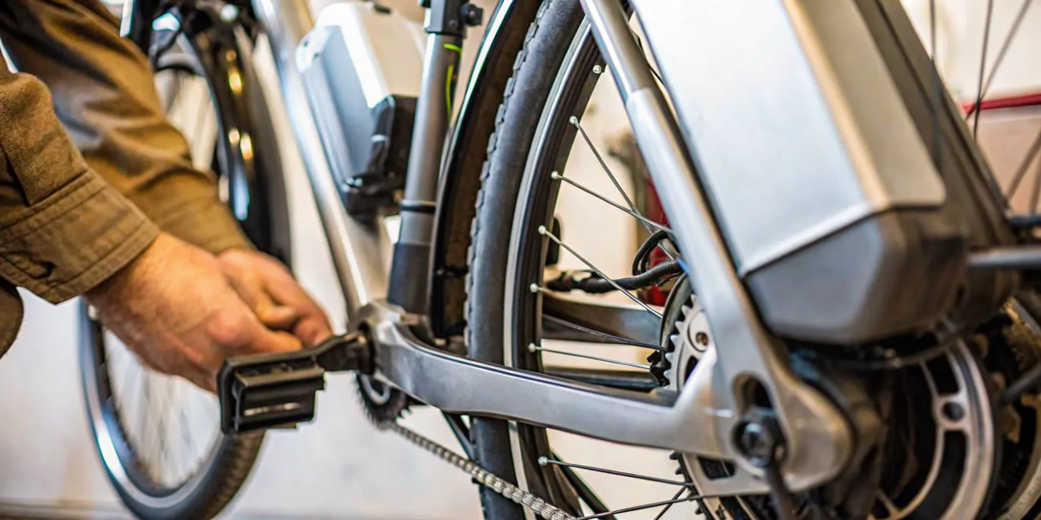 Detail of an electric bike motor and battery mounted on the frame in a bright bicycle showroom