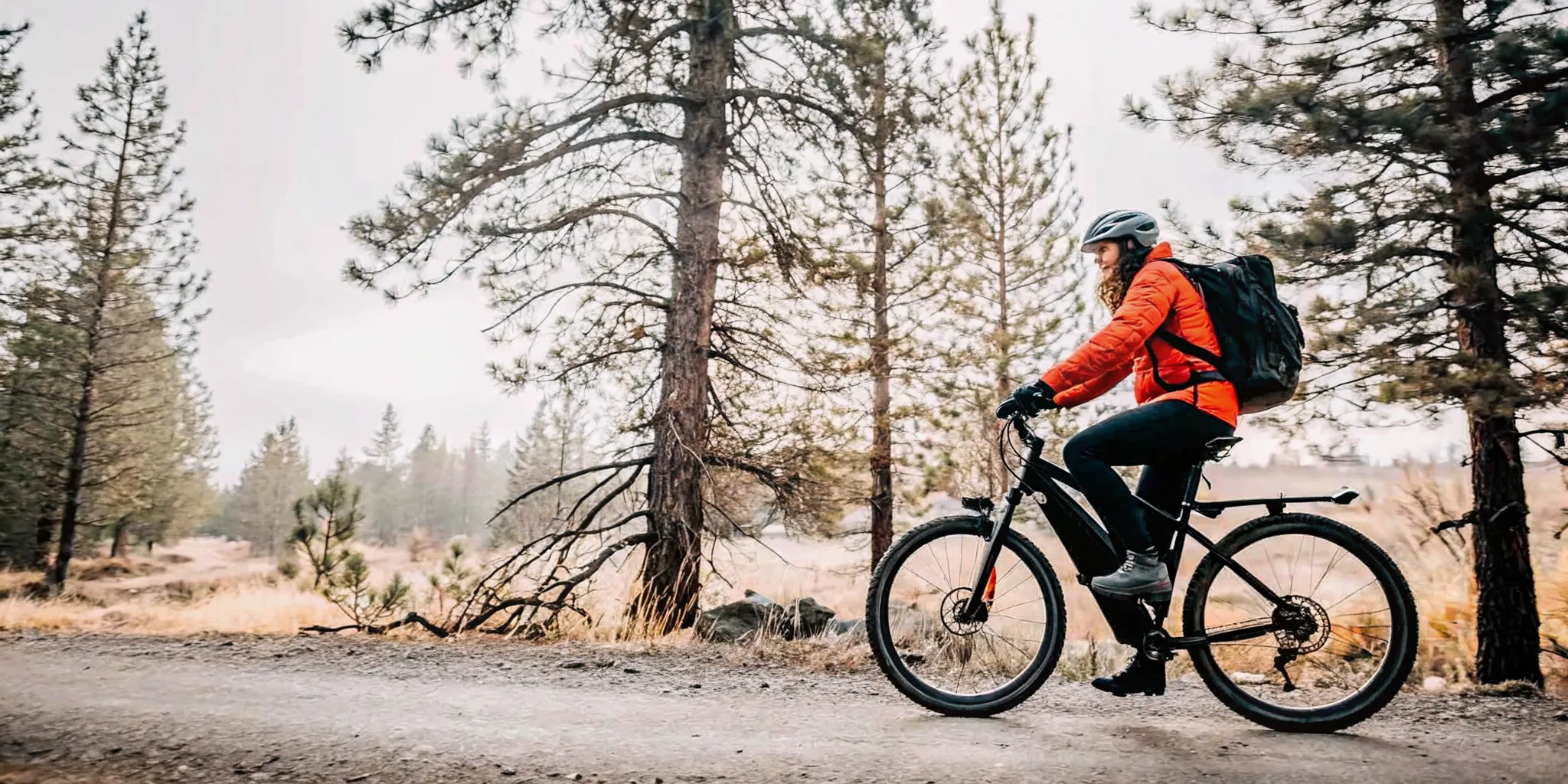 Rider guiding an off road electric bike across a narrow Central Oregon trail