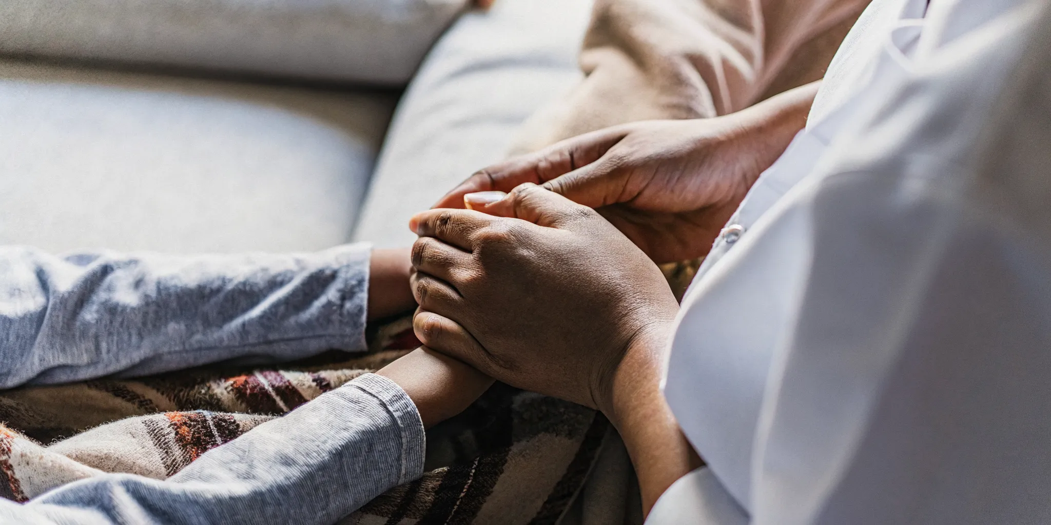 Pediatric nurse providing compassionate in-home care for a child in a warm family setting
