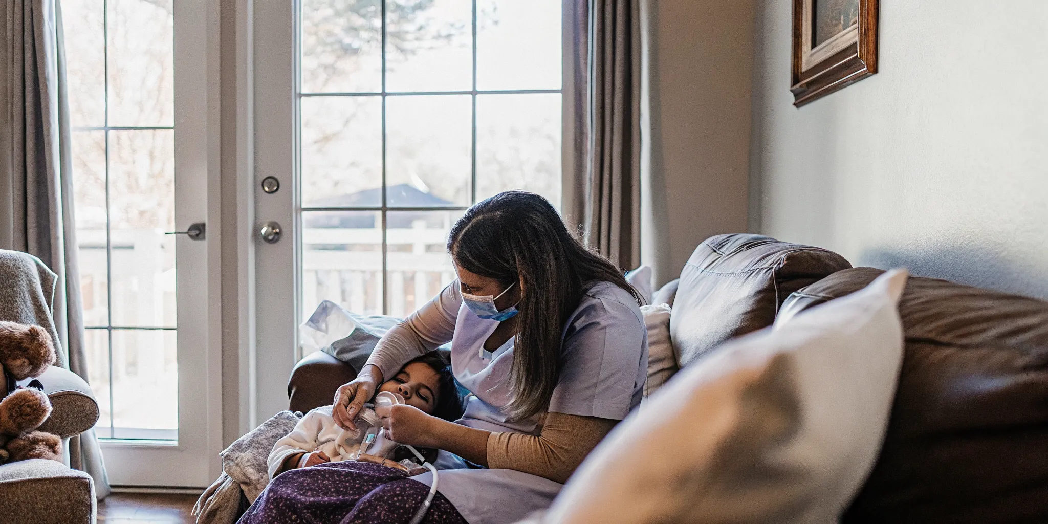 Pediatric home health nurse caring for a child with a G-tube feeding tube in a warm Georgia home setting