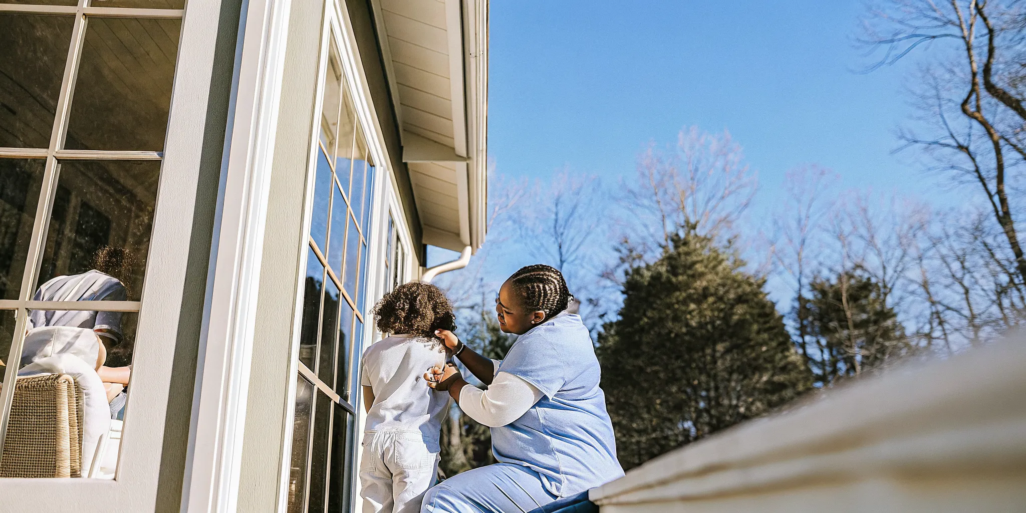 Pediatric home health care nurse supporting a child and parent in Georgia
