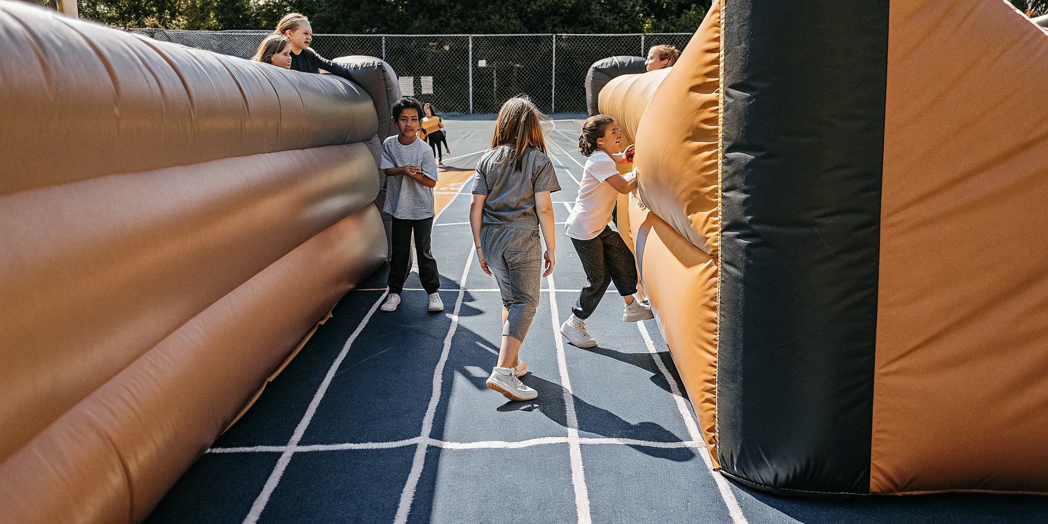 Students moving through school field day activity zones