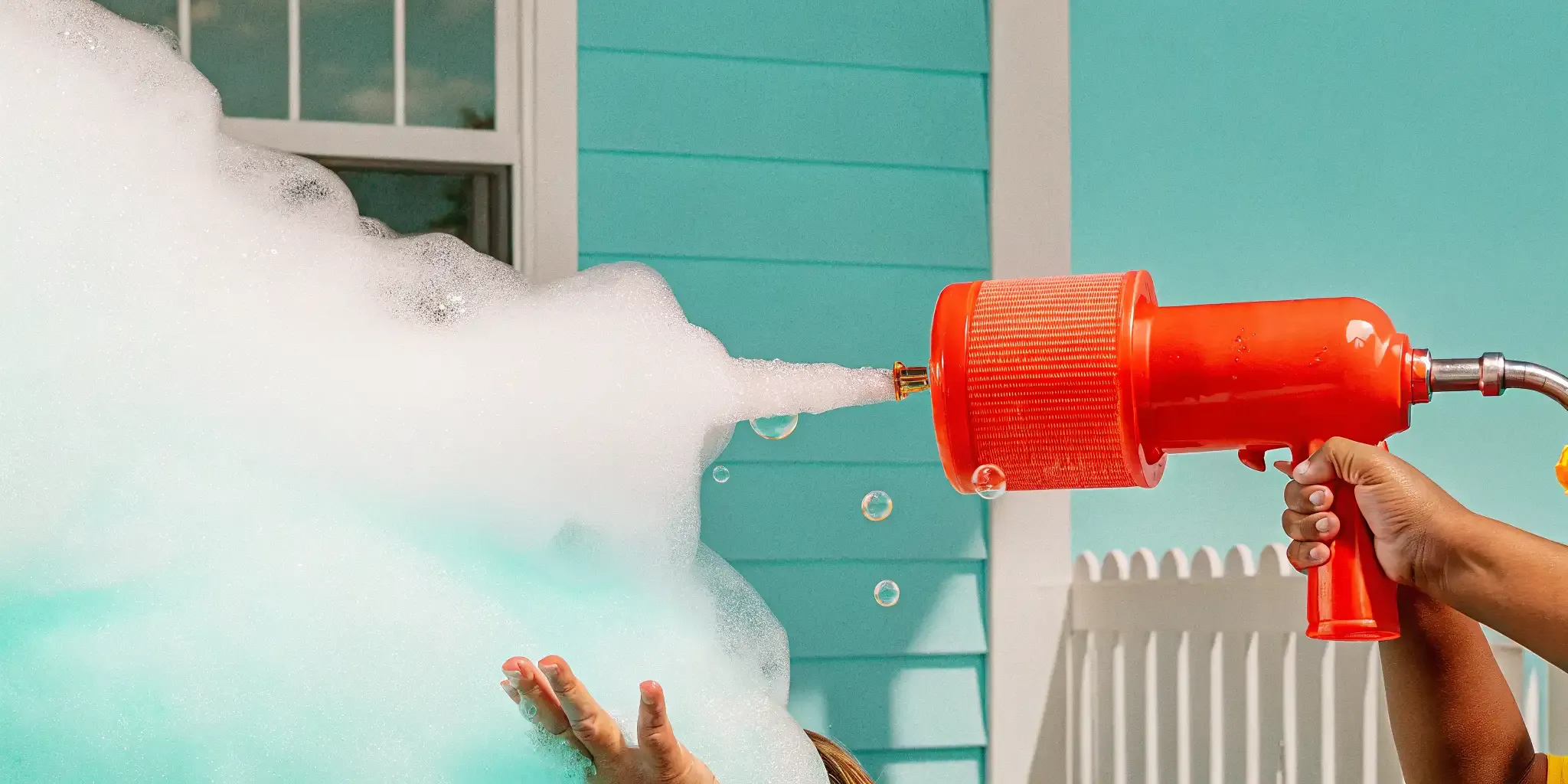 Professional foam machine spraying white foam at a backyard party near Norfolk Massachusetts