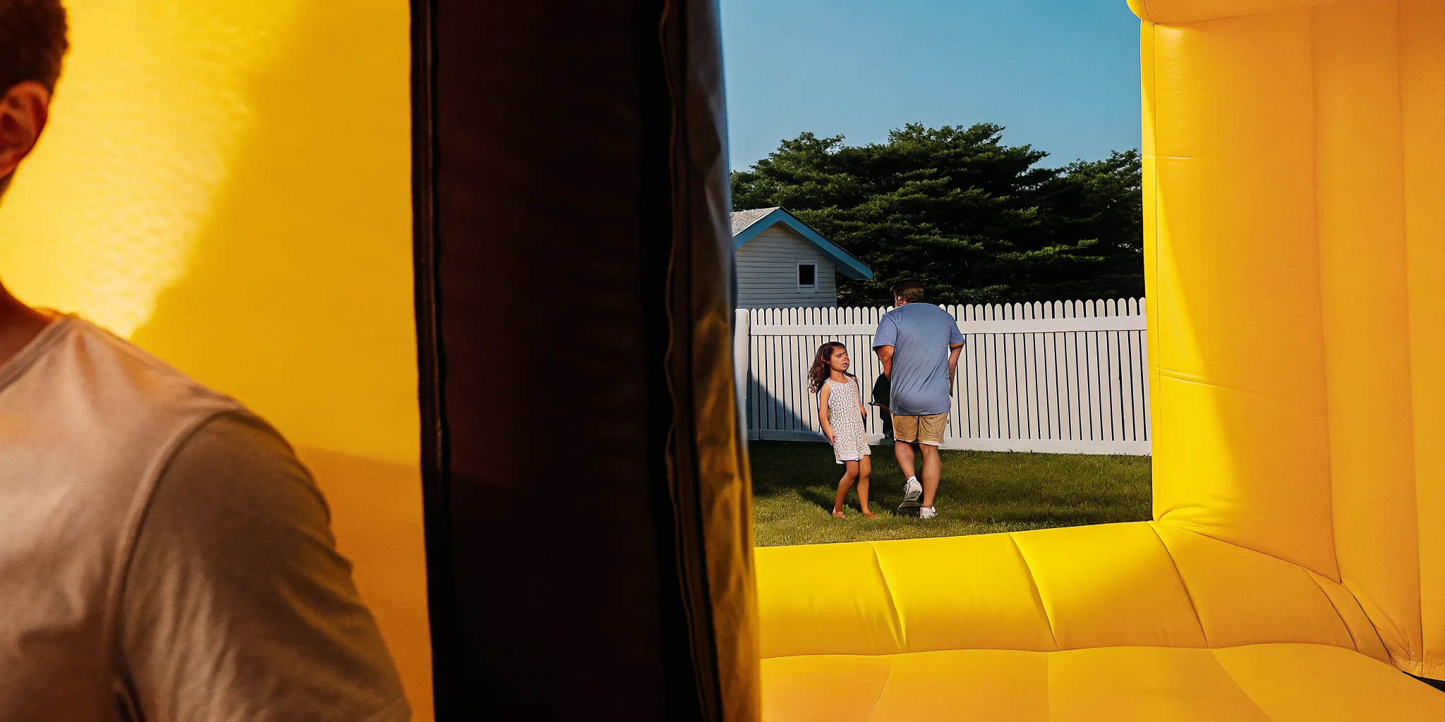 Professional setup of a bounce house rental in a Rhode Island backyard