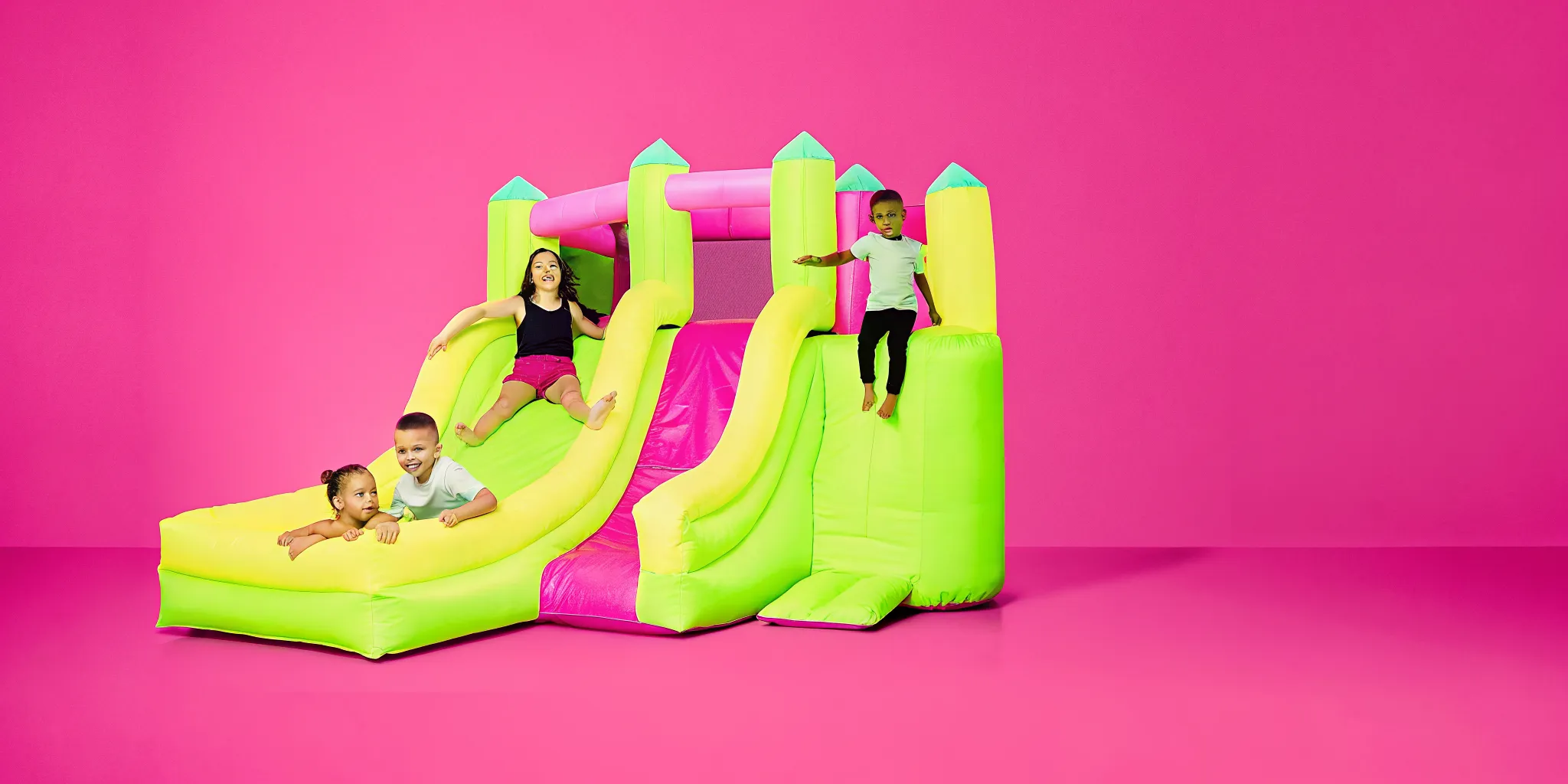 Massachusetts backyard party with a bounce house and water slide rental set up for summer entertainment