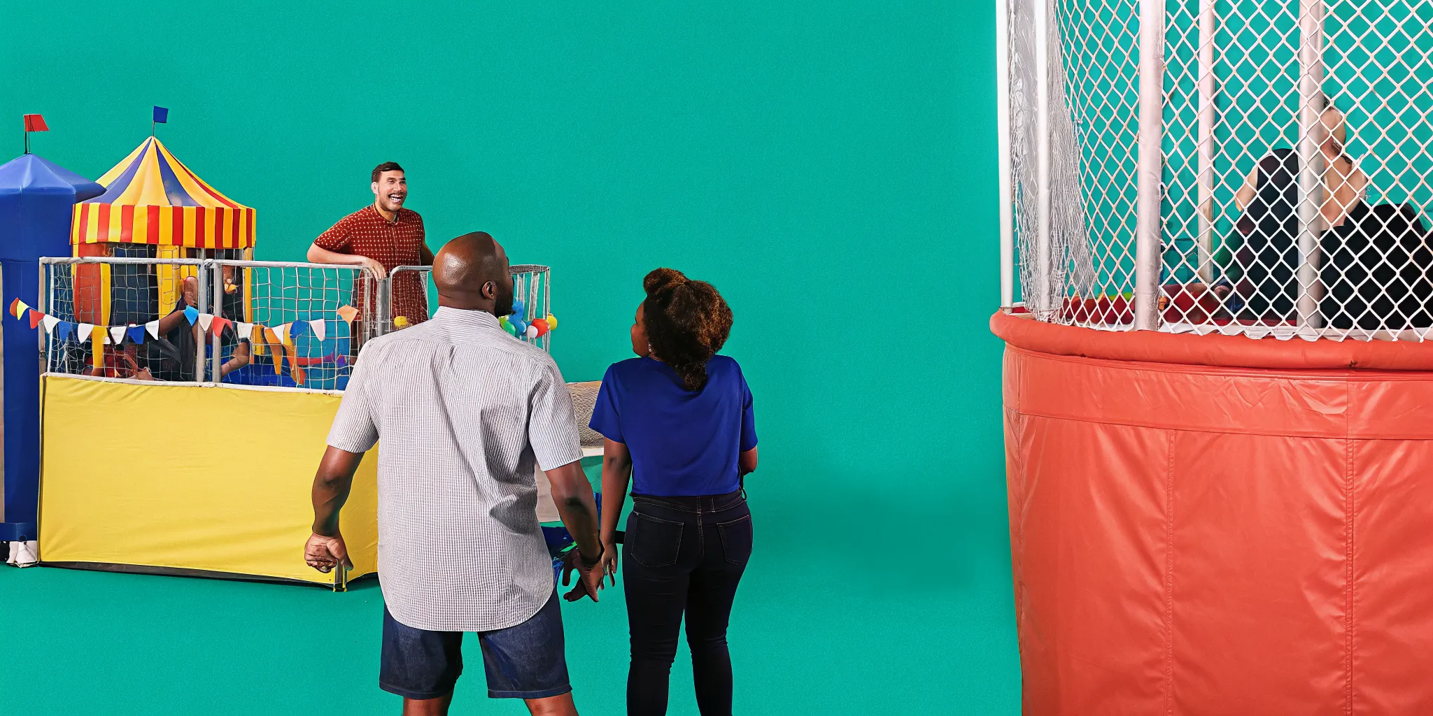 Outdoor dunk tank setup at a summer carnival in Massachusetts with guests lined up