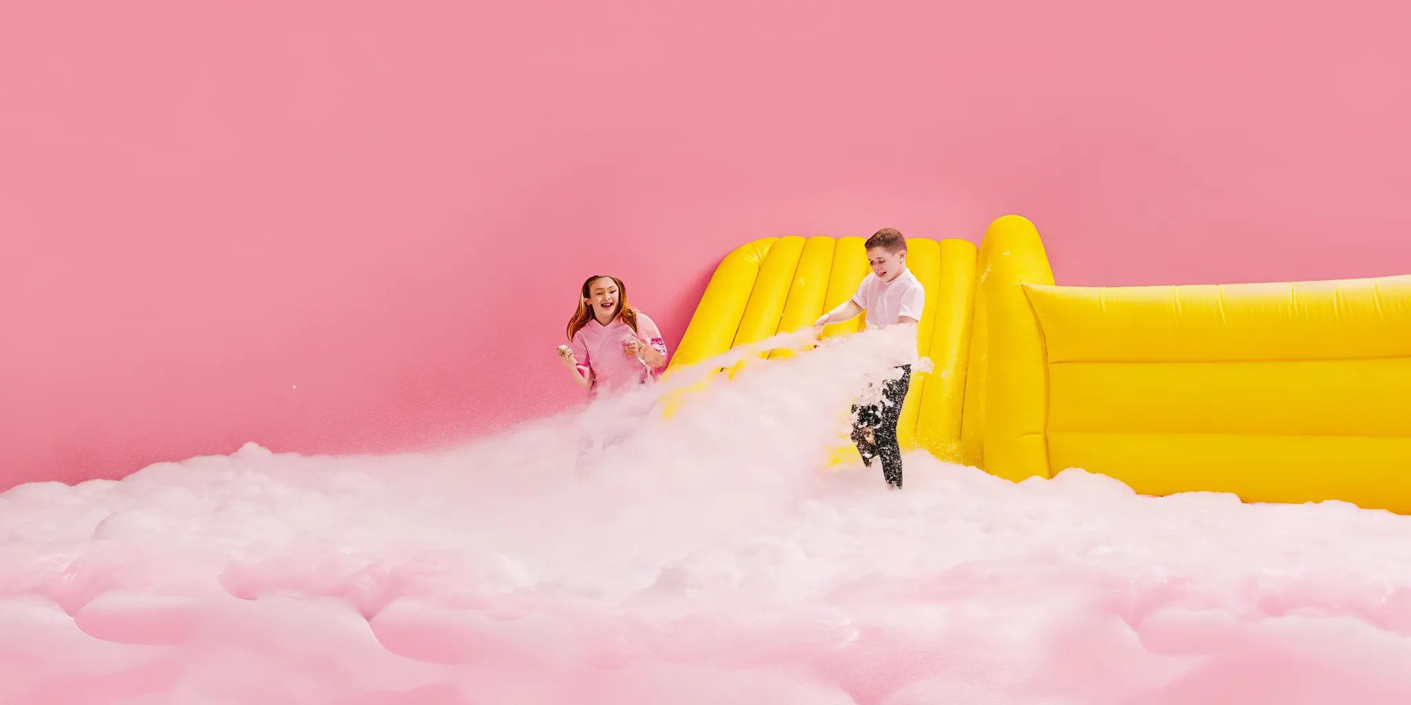 AJT Bounce foam cannon and inflatable play setup in a Massachusetts backyard showing the equipment layout