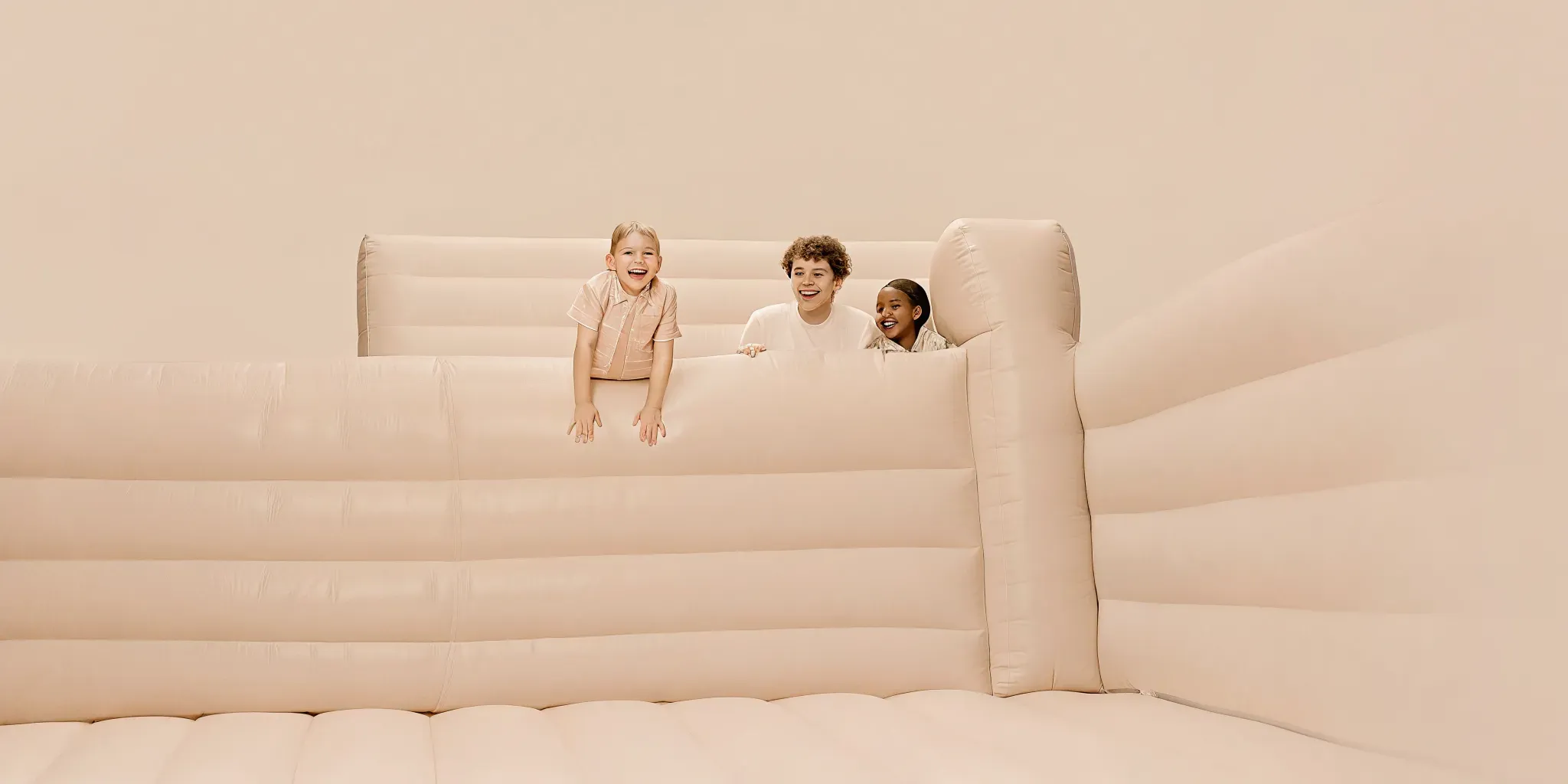 Adults supervising children playing safely inside a bounce house at a Massachusetts backyard birthday party