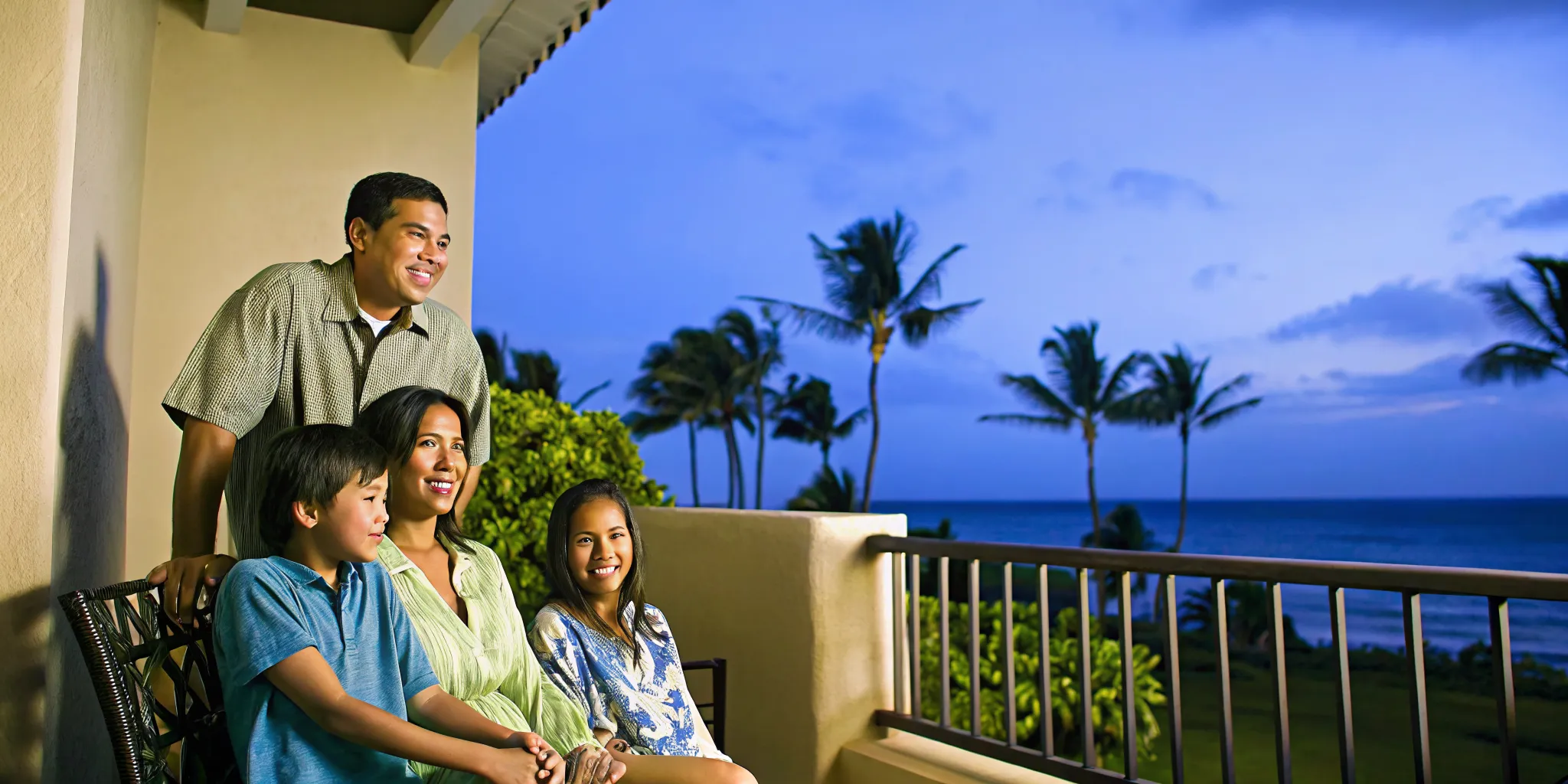 Family talking together on a lanai overlooking the ocean in Hawaii