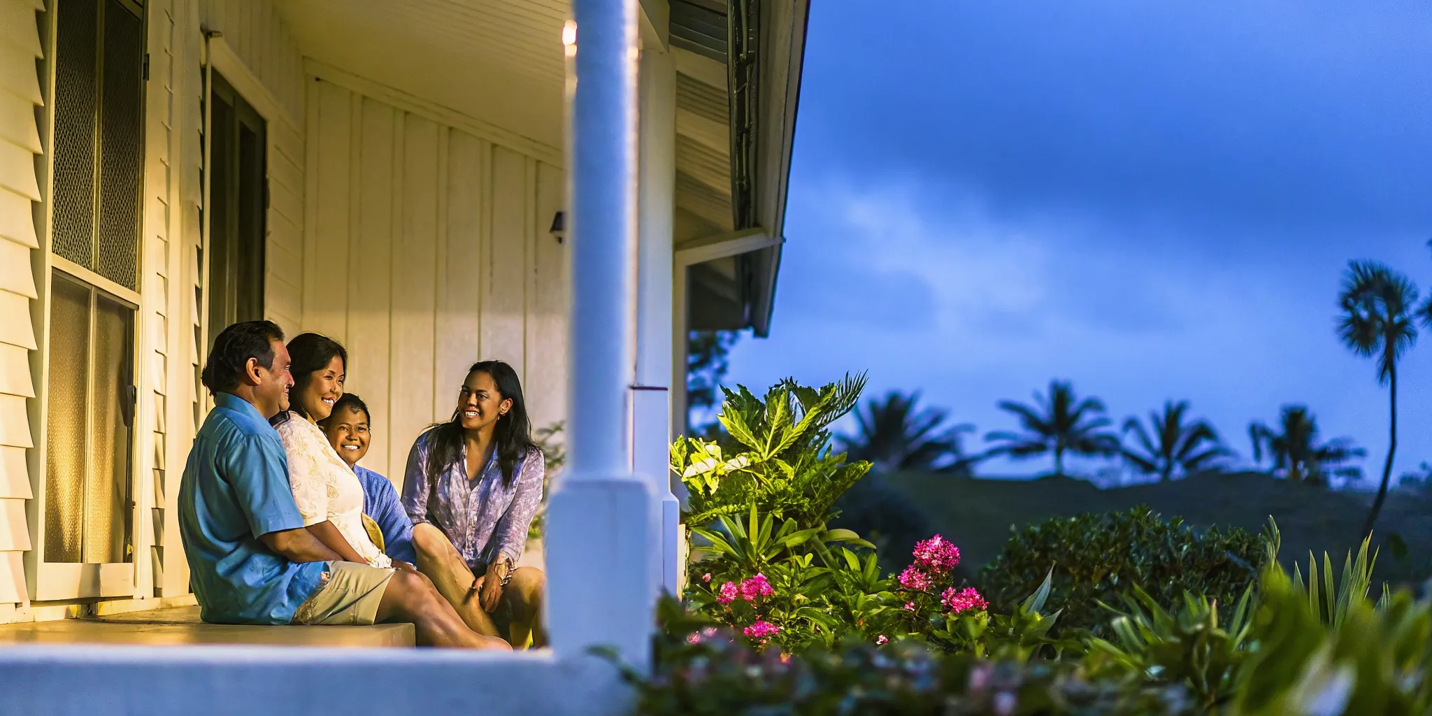 A Hawaii family sitting together on a lanai having a calm, heartfelt conversation