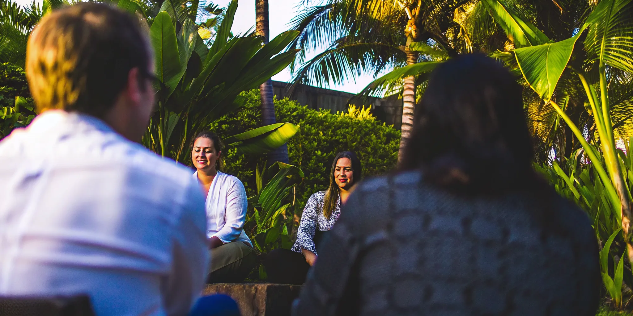 Lush outdoor group therapy session at Mana Recovery center in Hawaii, where therapists work with patients in a supportive environment