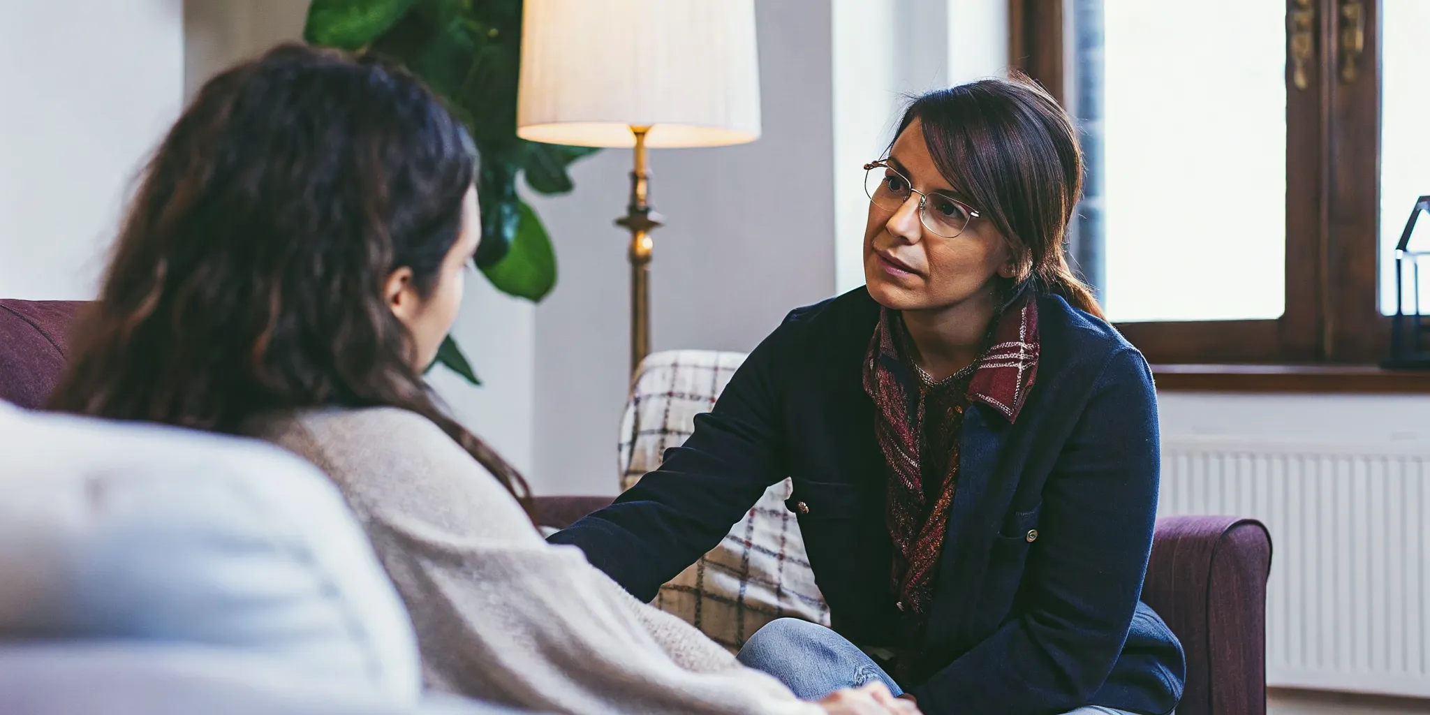Counselor using motivational interviewing for addiction during a private session