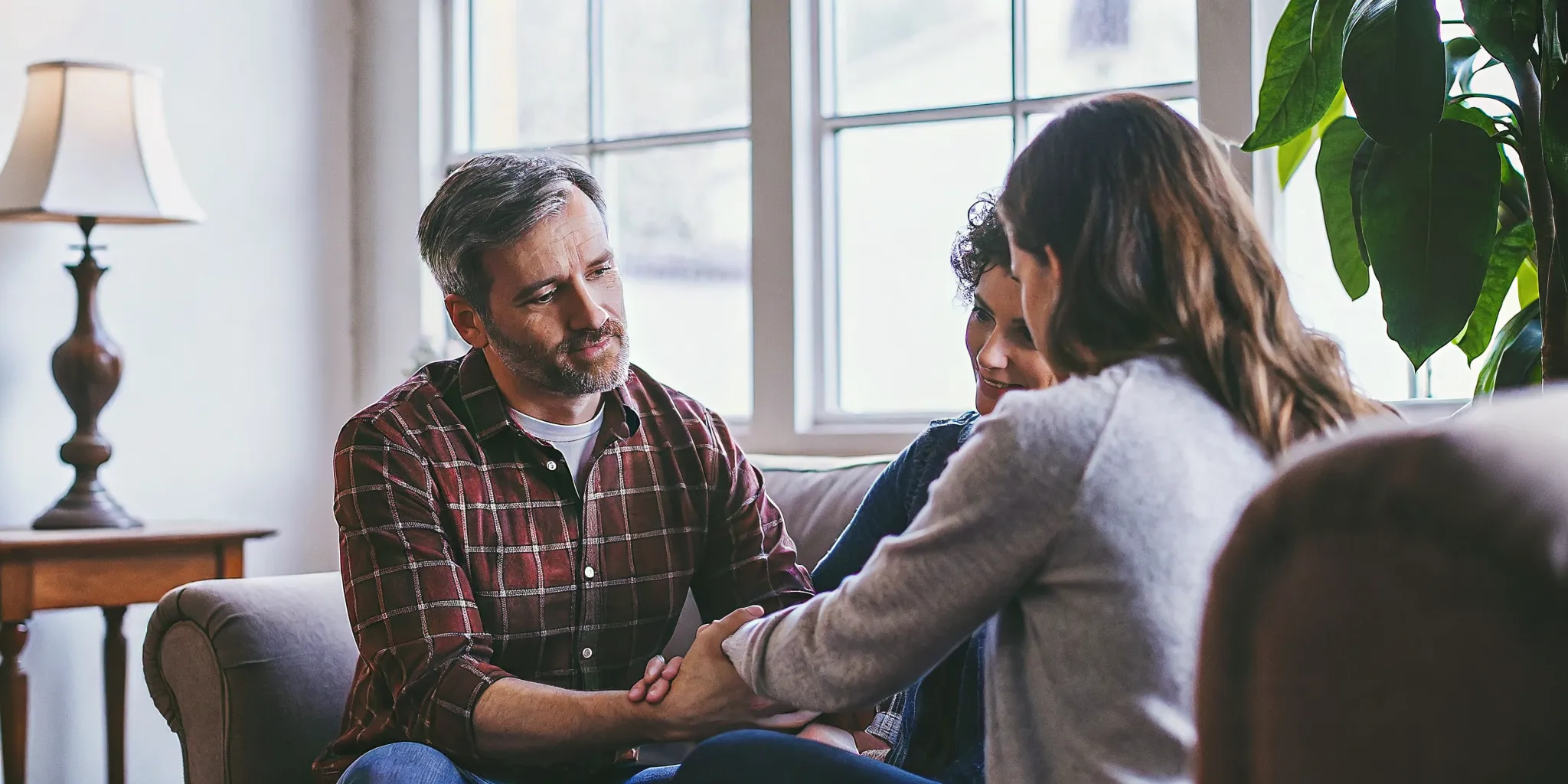 Family having a calm conversation about how to support someone after rehab