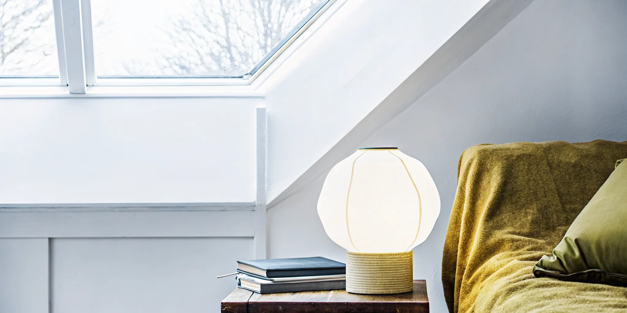 Modern living room with a sculptural lamp as a playful focal point, warm natural light and curated decor