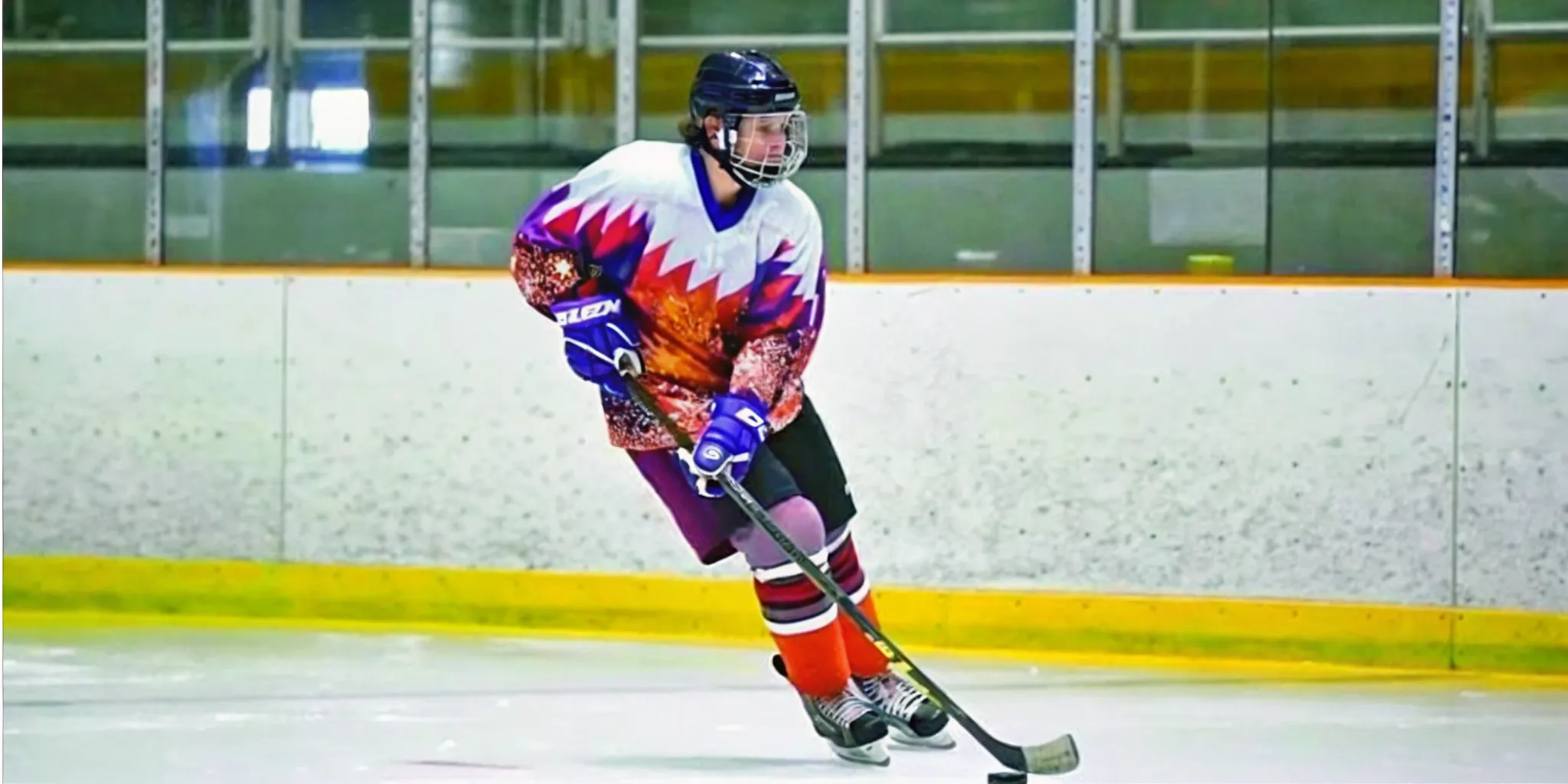 Ice hockey player in a sublimated custom jersey during game action on a professional rink