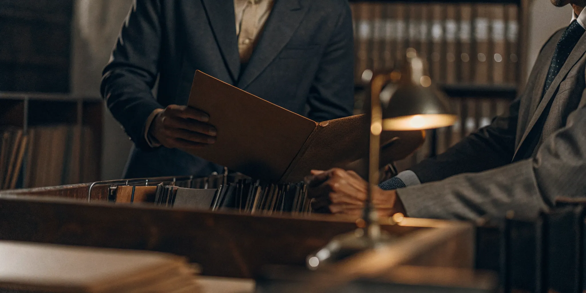 Attorney reviewing medical bills and hospital lien paperwork for a personal injury settlement case at a desk