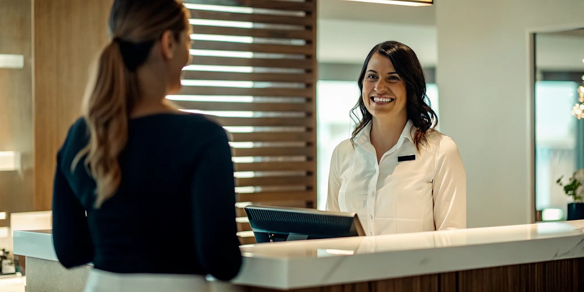 Med spa front desk team preparing member welcome packet at check-in counter