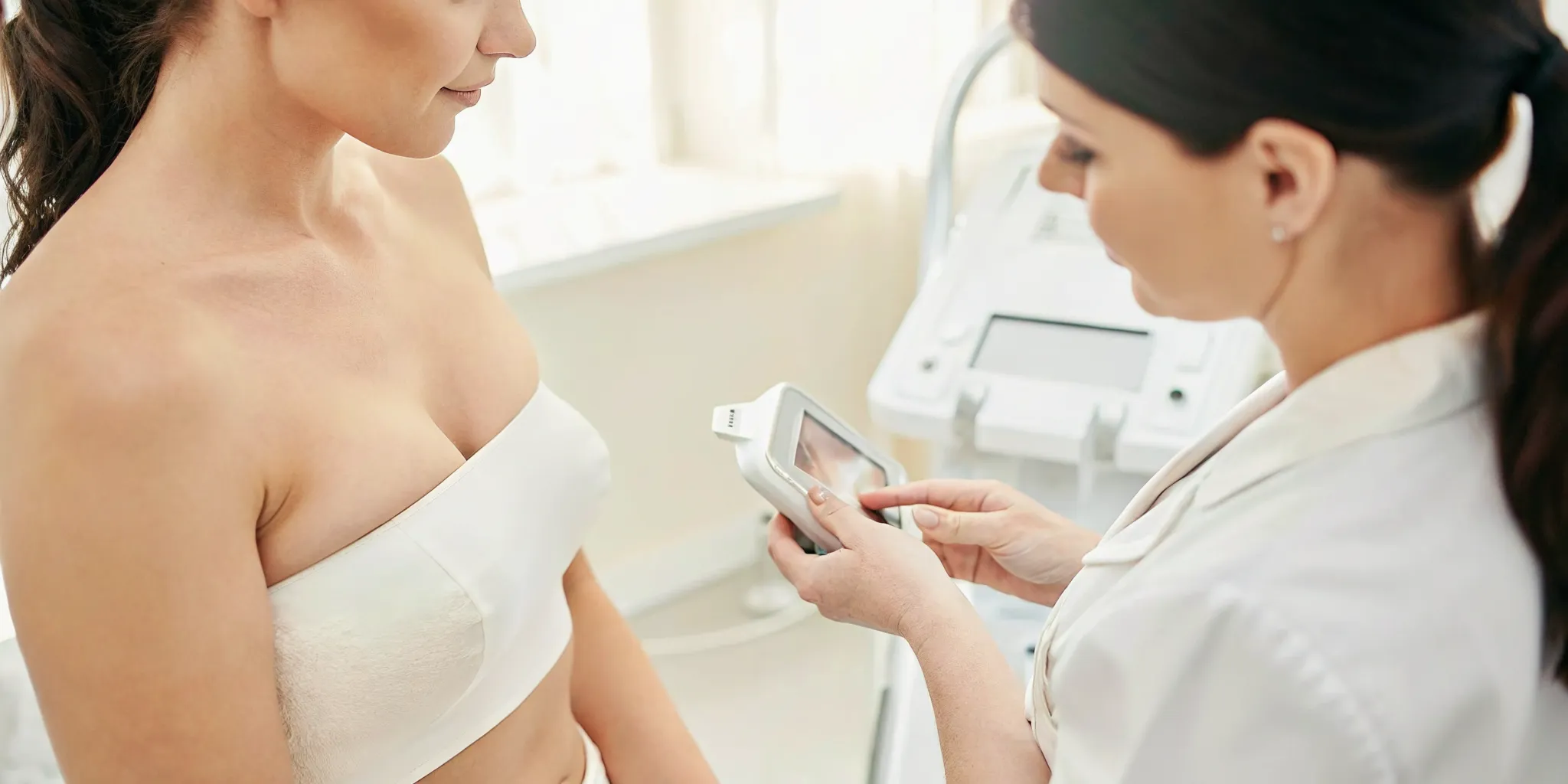 Licensed aesthetic professional discussing non surgical skin tightening options with a client