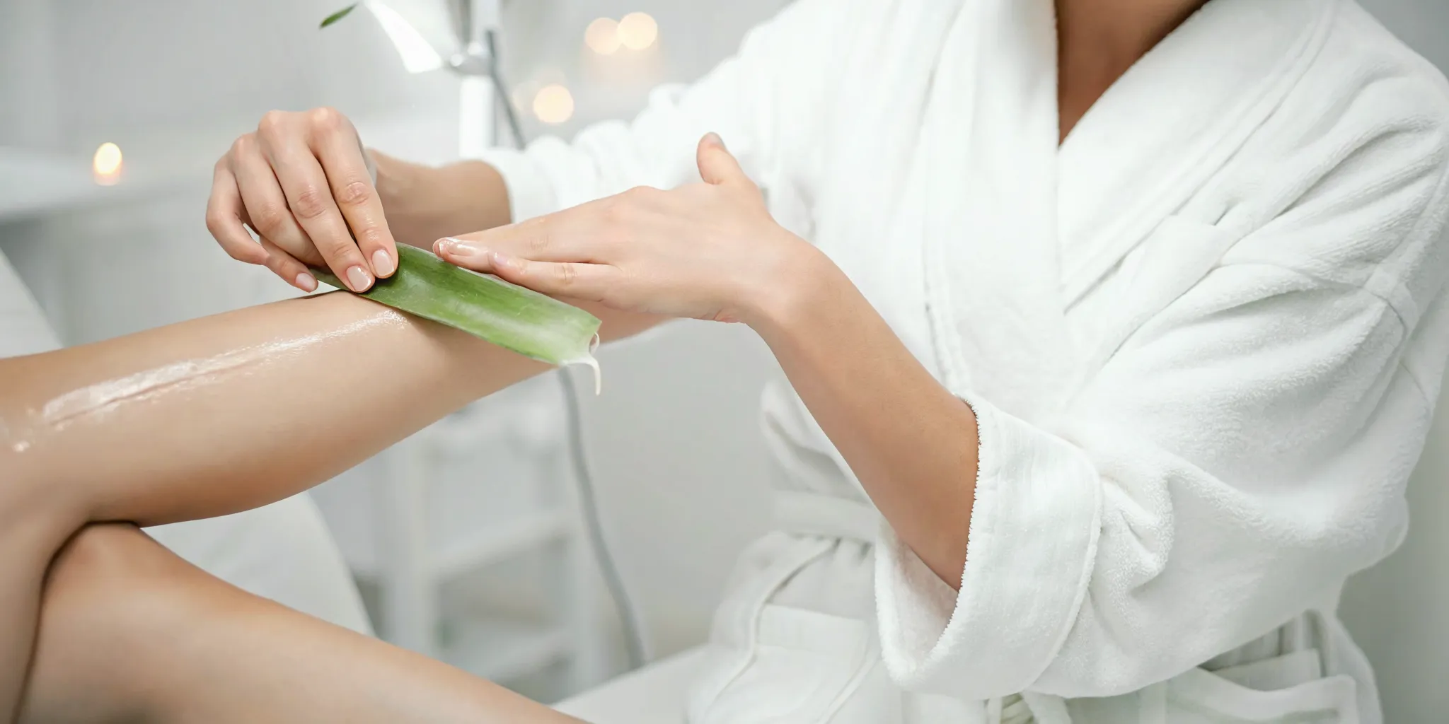 woman applying soothing gel to arm after laser hair removal treatment