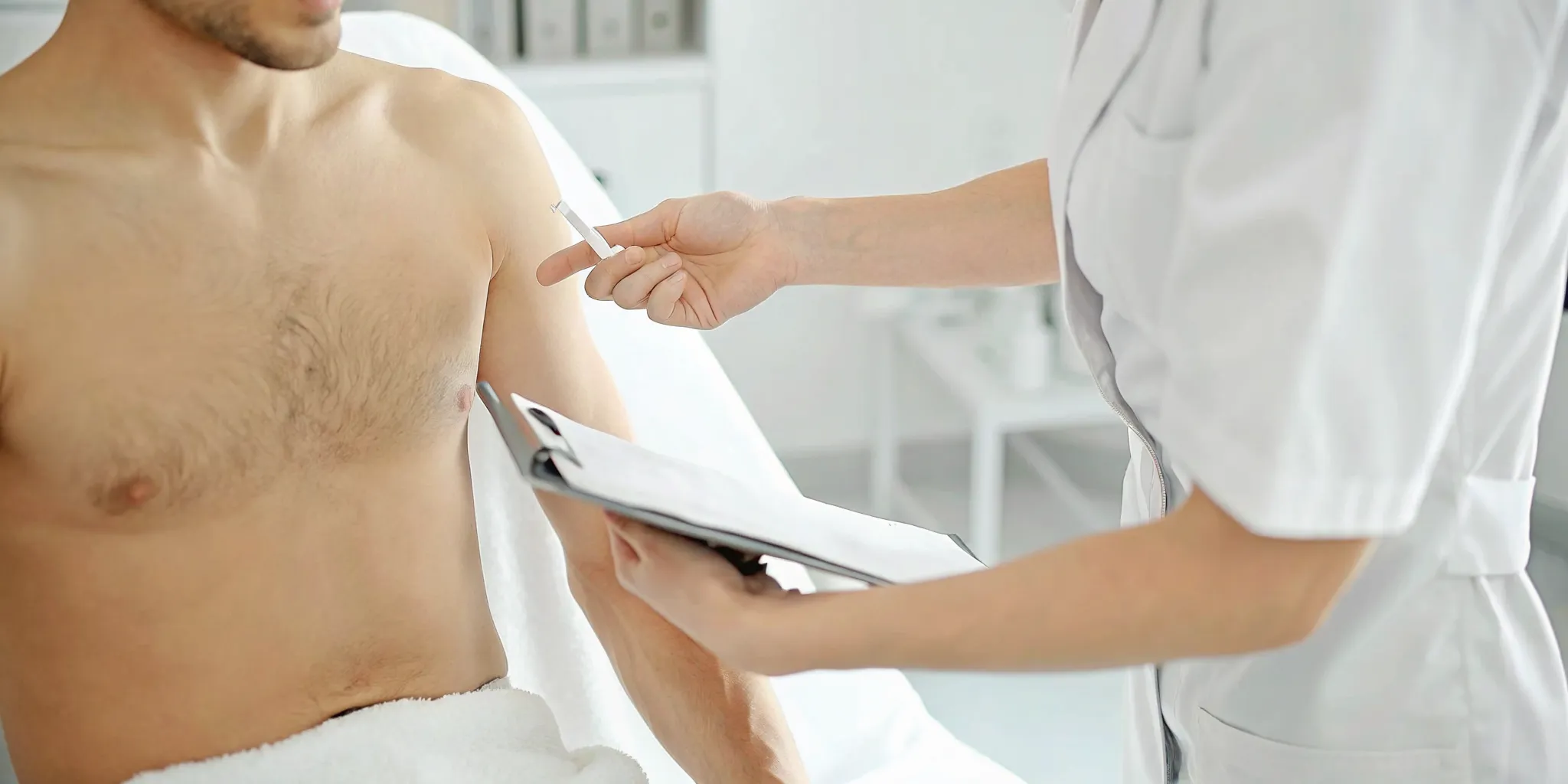 Man discussing chest laser hair removal treatment planning with a licensed professional