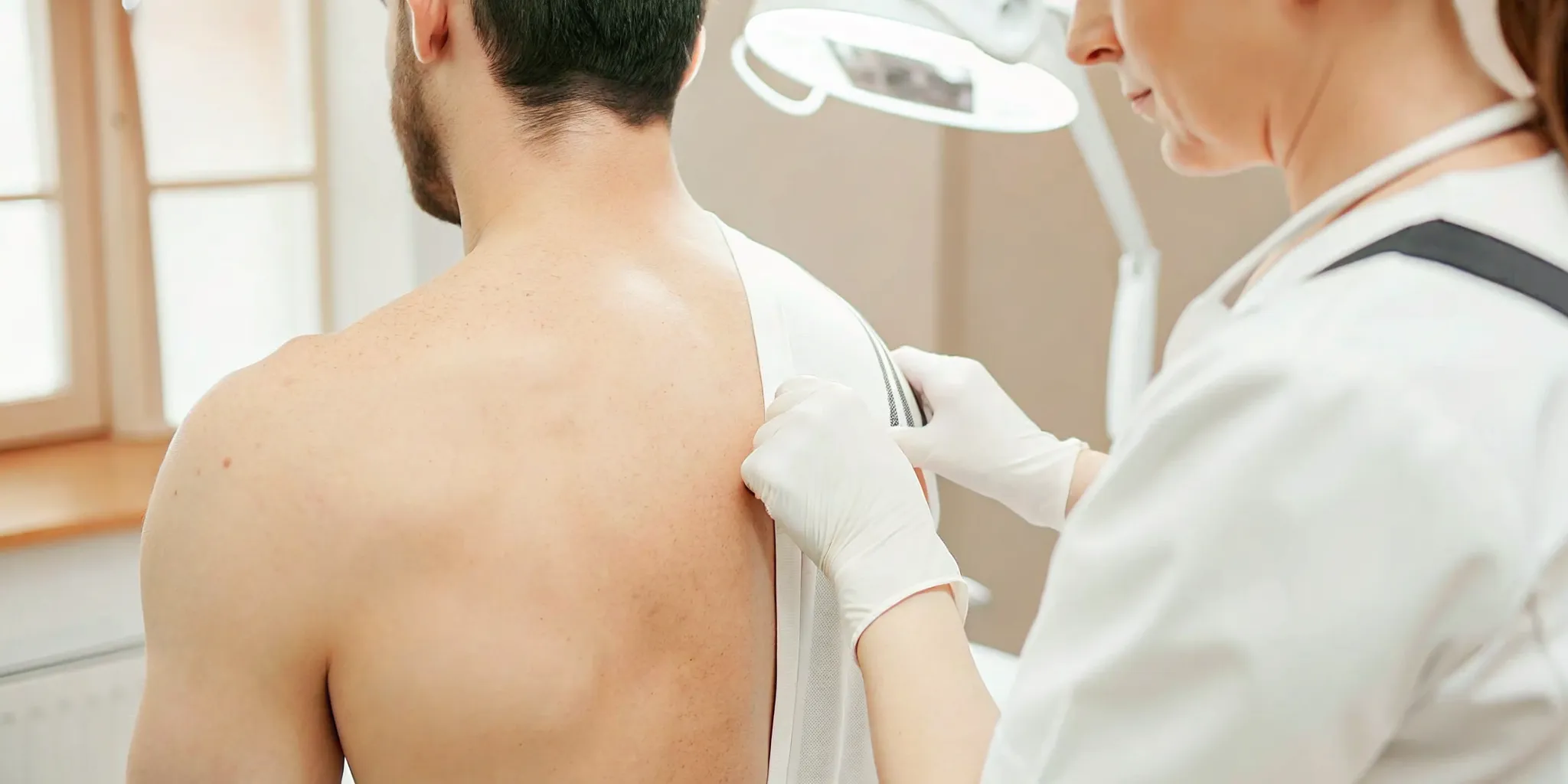 Man discussing back and shoulder laser hair removal with a licensed professional