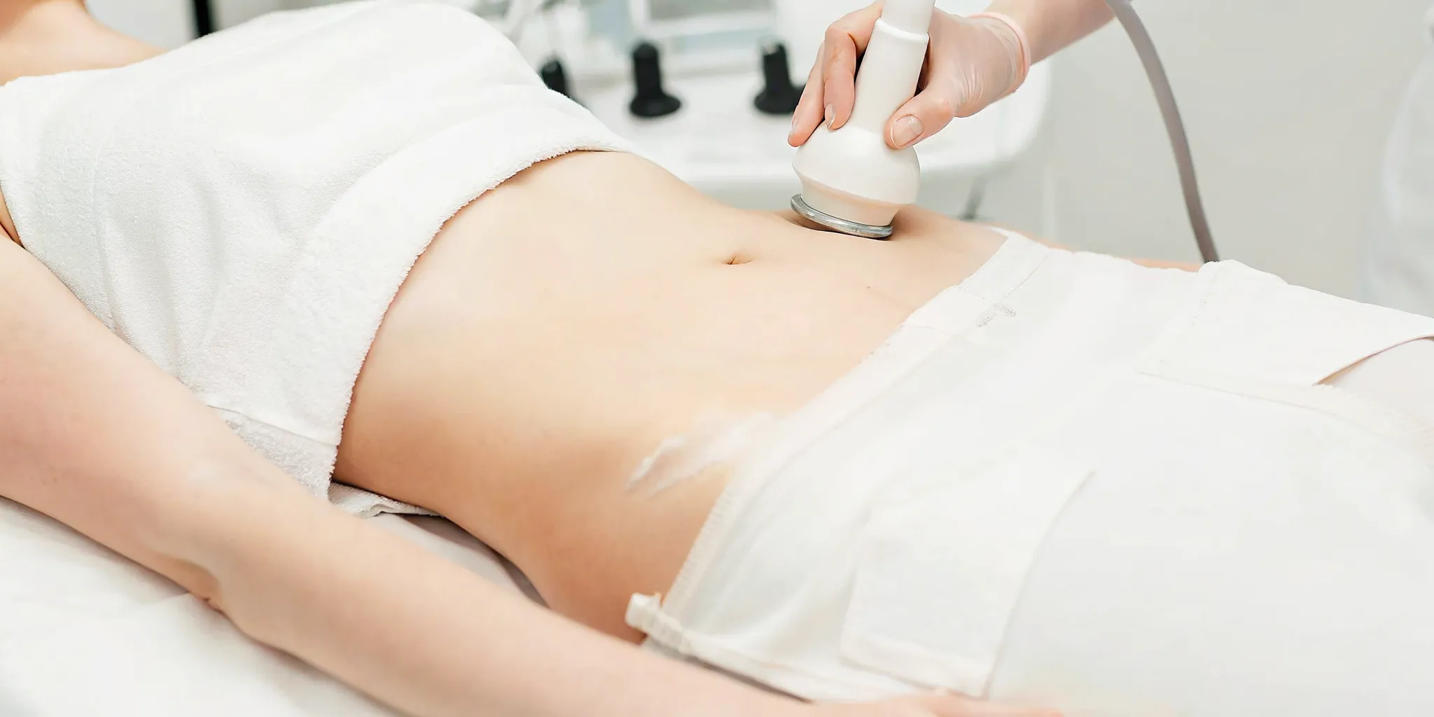 UltraShape ultrasound treatment applicator on a patient abdomen at a medical spa