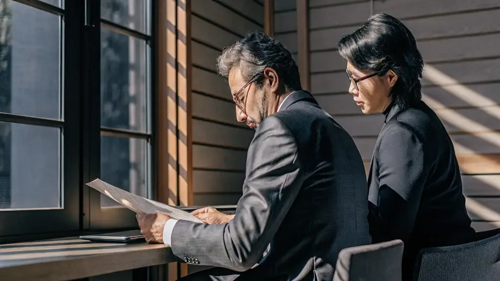 Washington business owner reviewing health insurance plan options with a professional advisor in a modern office setting