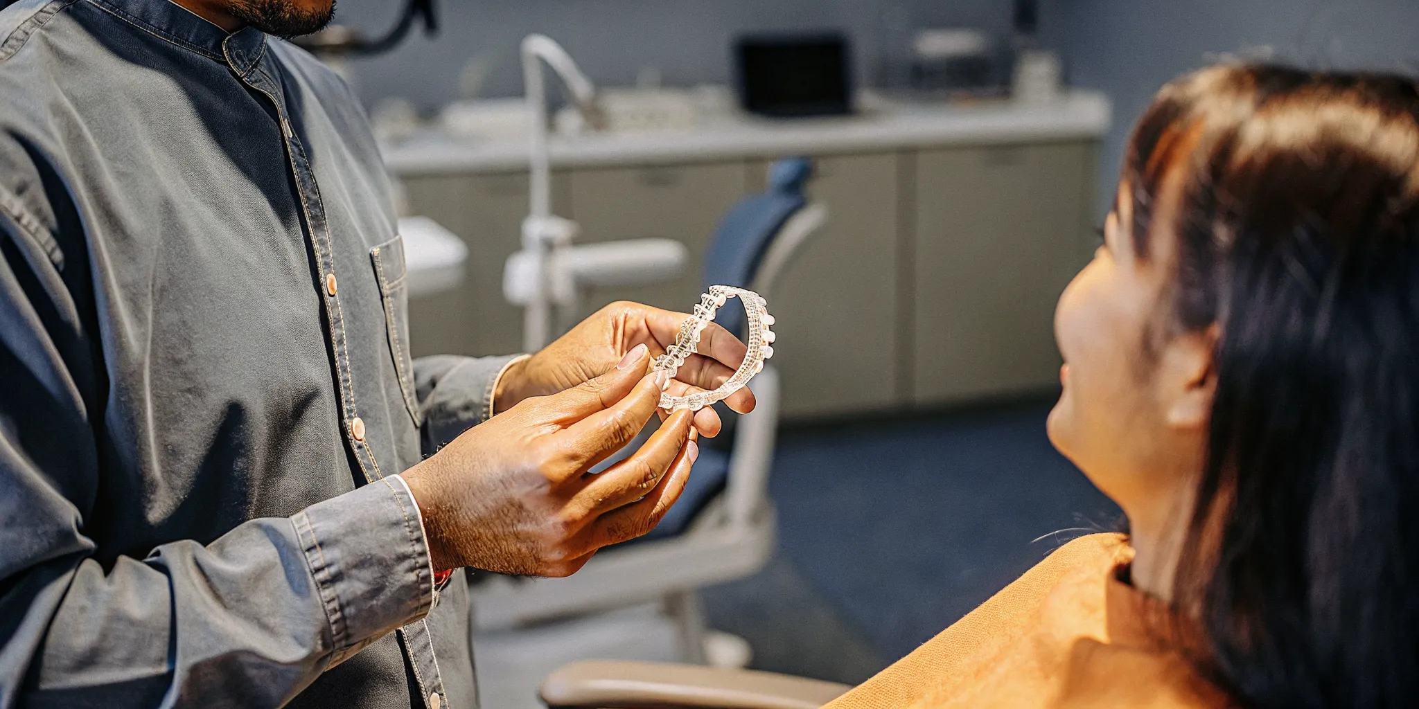 Dentist explaining a custom sleep apnea oral appliance to a patient