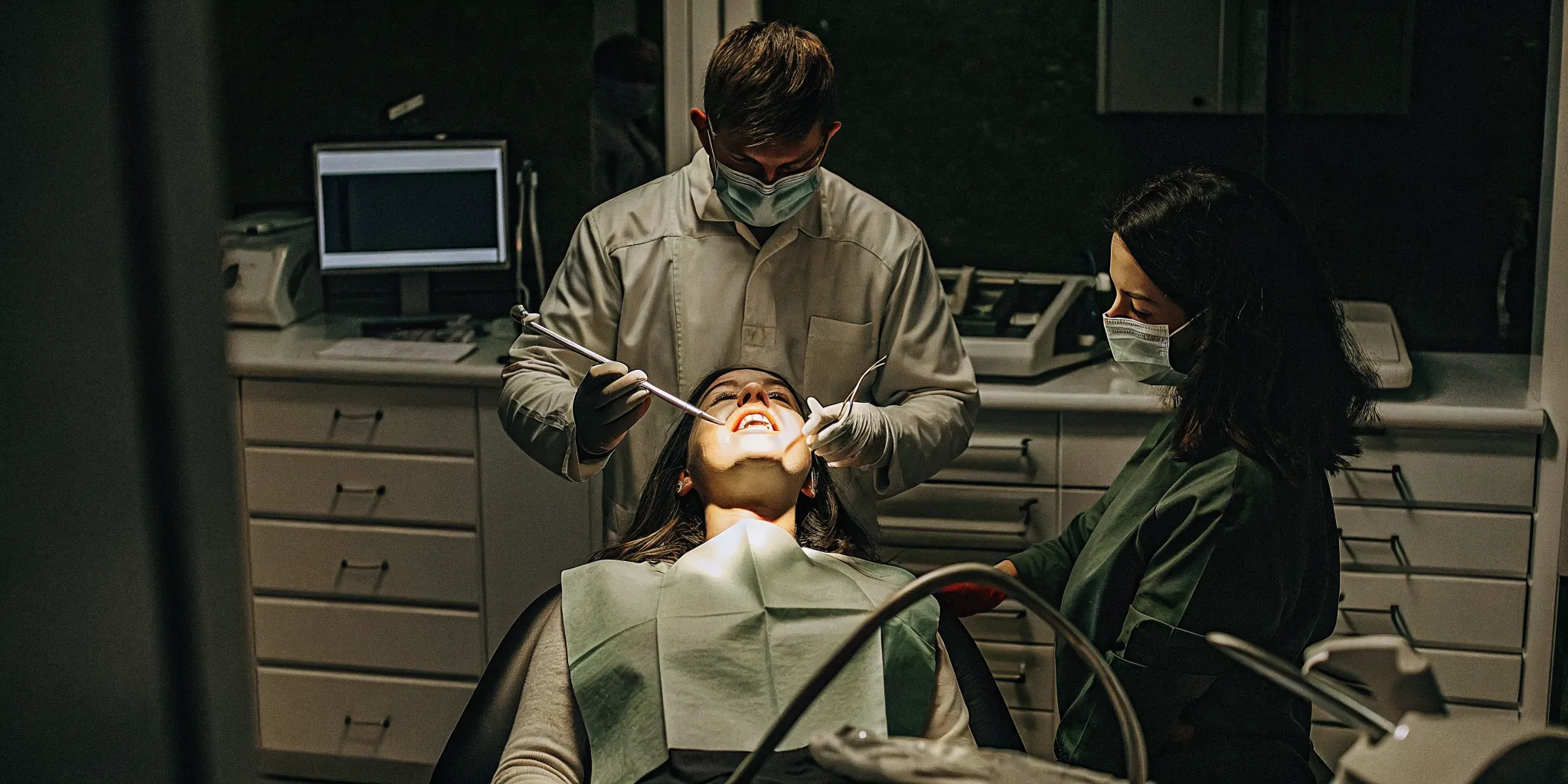 Dental patient relaxing comfortably while dentist monitors vital signs with modern equipment in a calm Hillcrest office