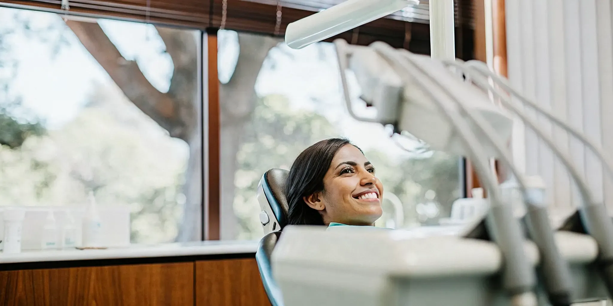 Dental team monitoring a relaxed patient in a modern San Diego dental suite with warm natural light